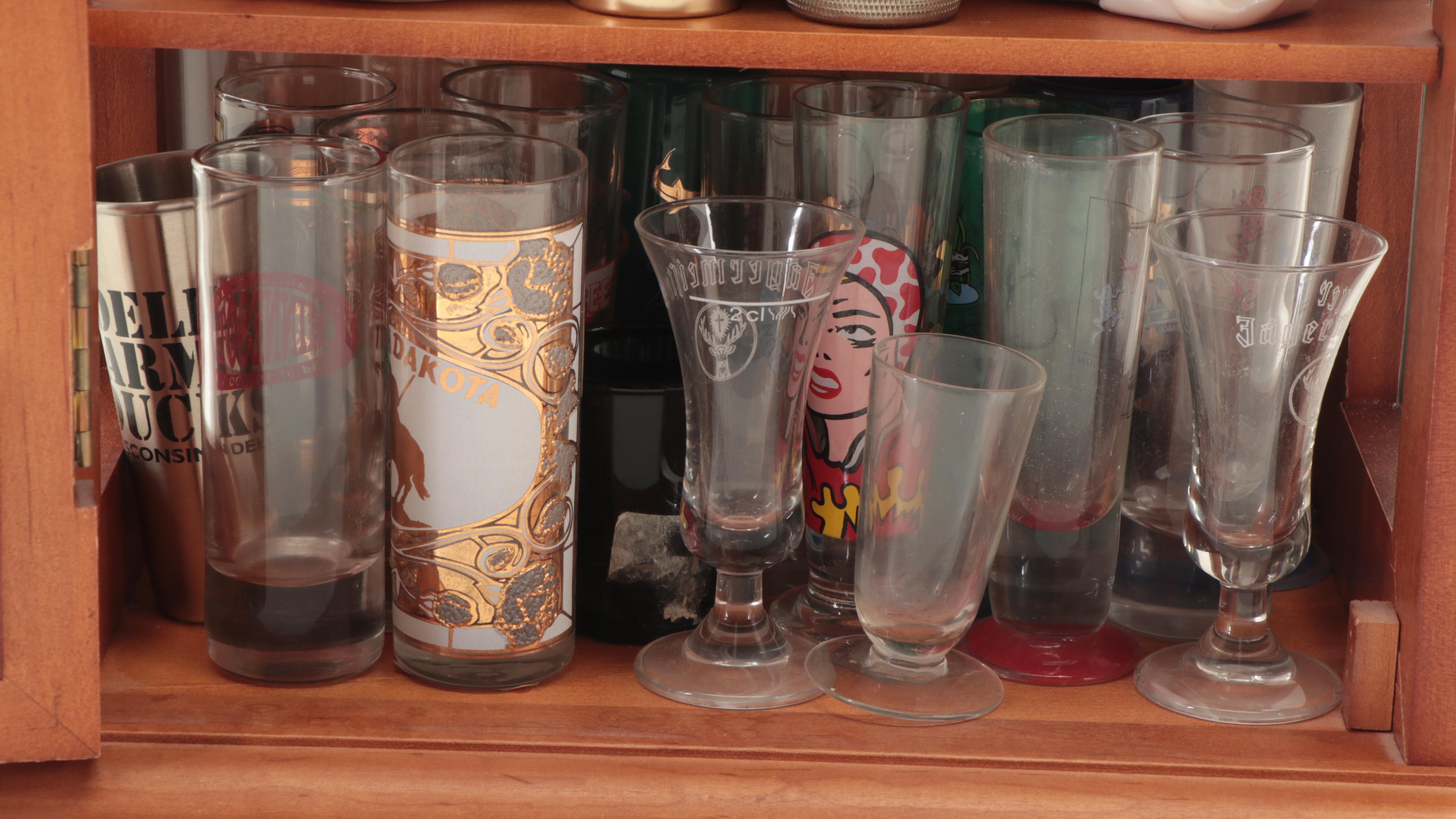 Souvenir Shot Glasses and Shakers in Wall Display Cabinet