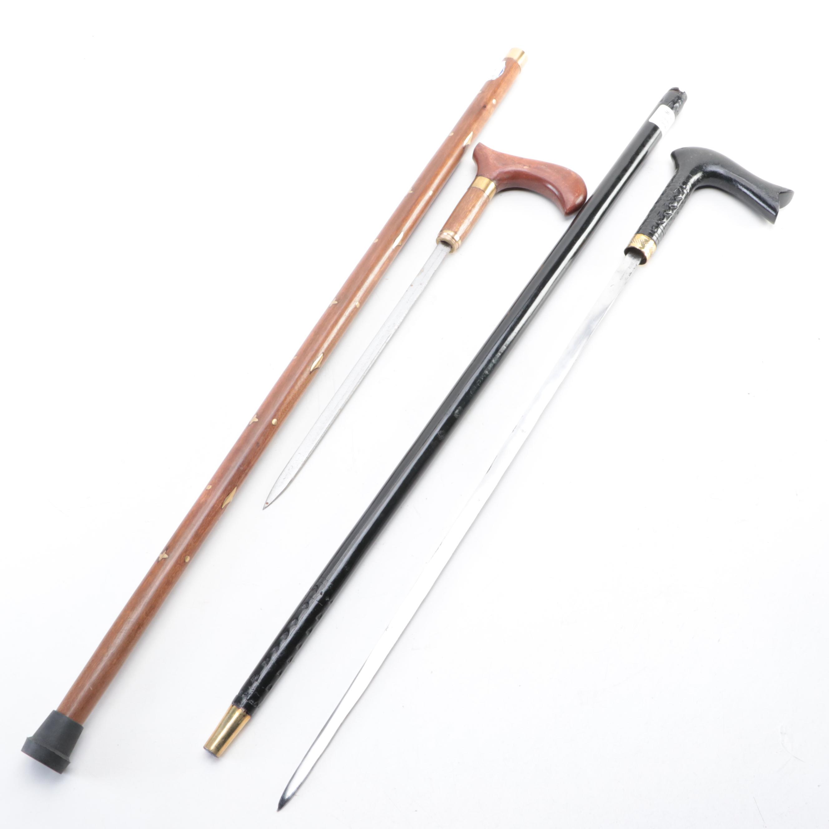 Two Ebonized and Brass Inlaid Sword Canes with Steel Blades