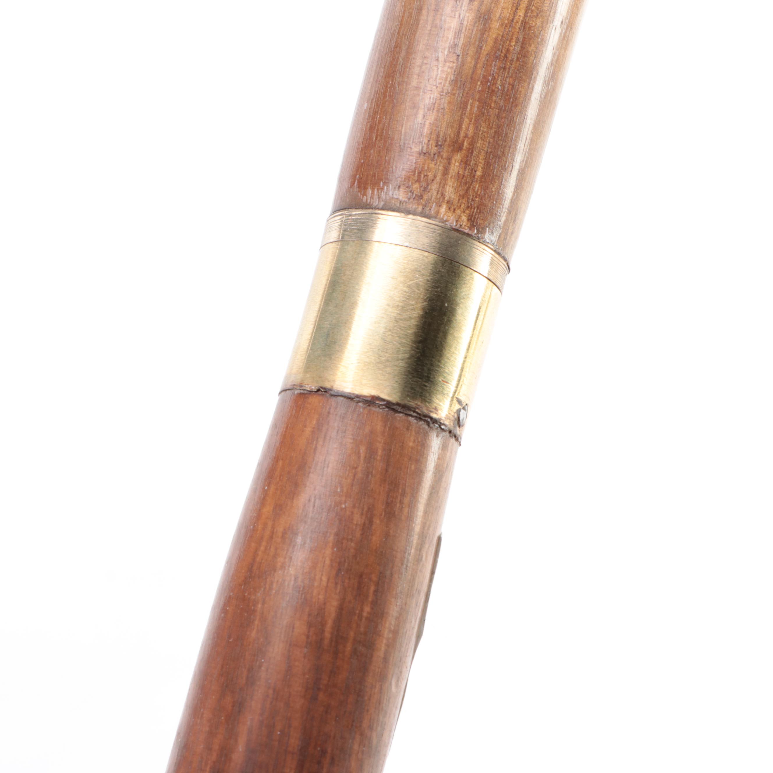 Two Ebonized and Brass Inlaid Sword Canes with Steel Blades