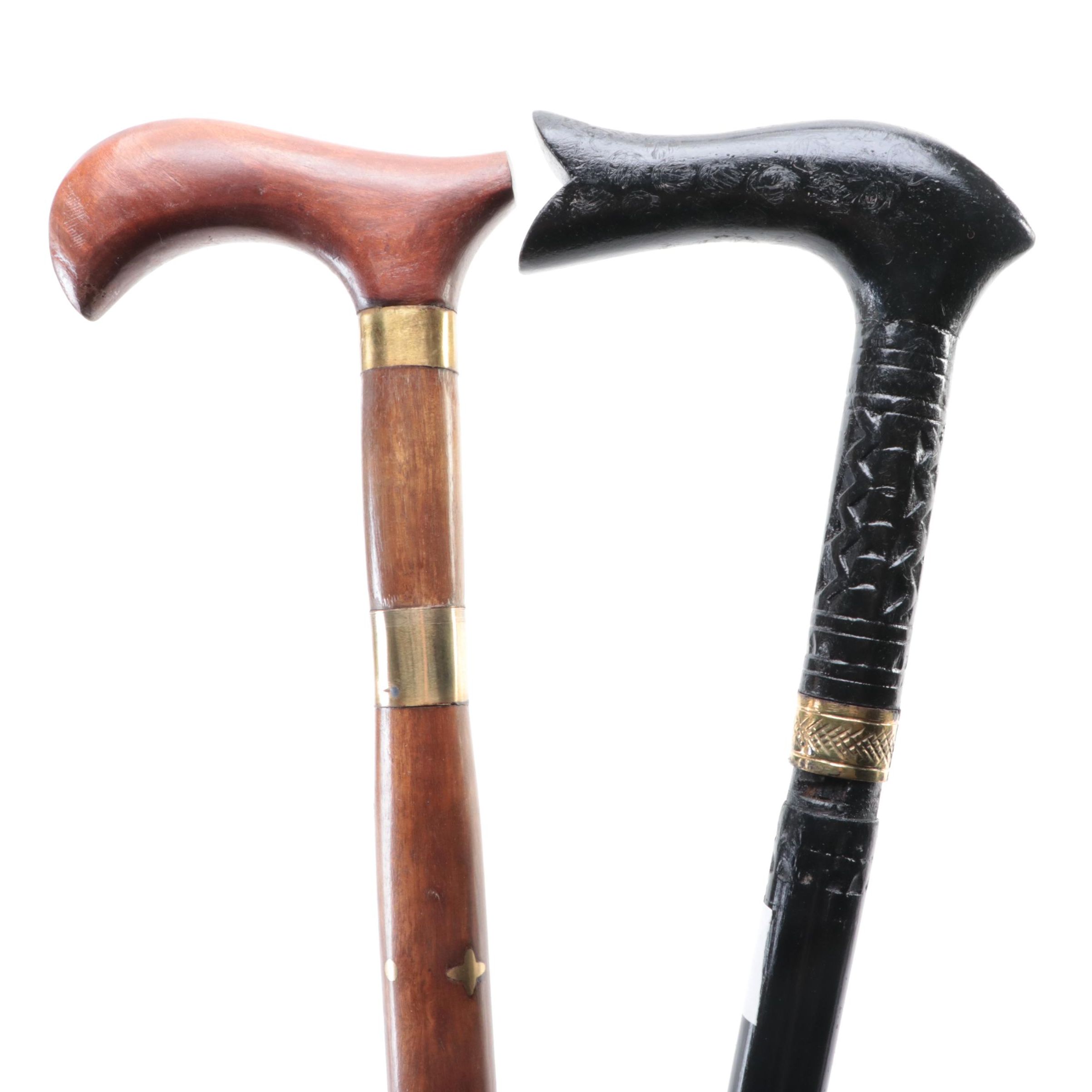 Two Ebonized and Brass Inlaid Sword Canes with Steel Blades
