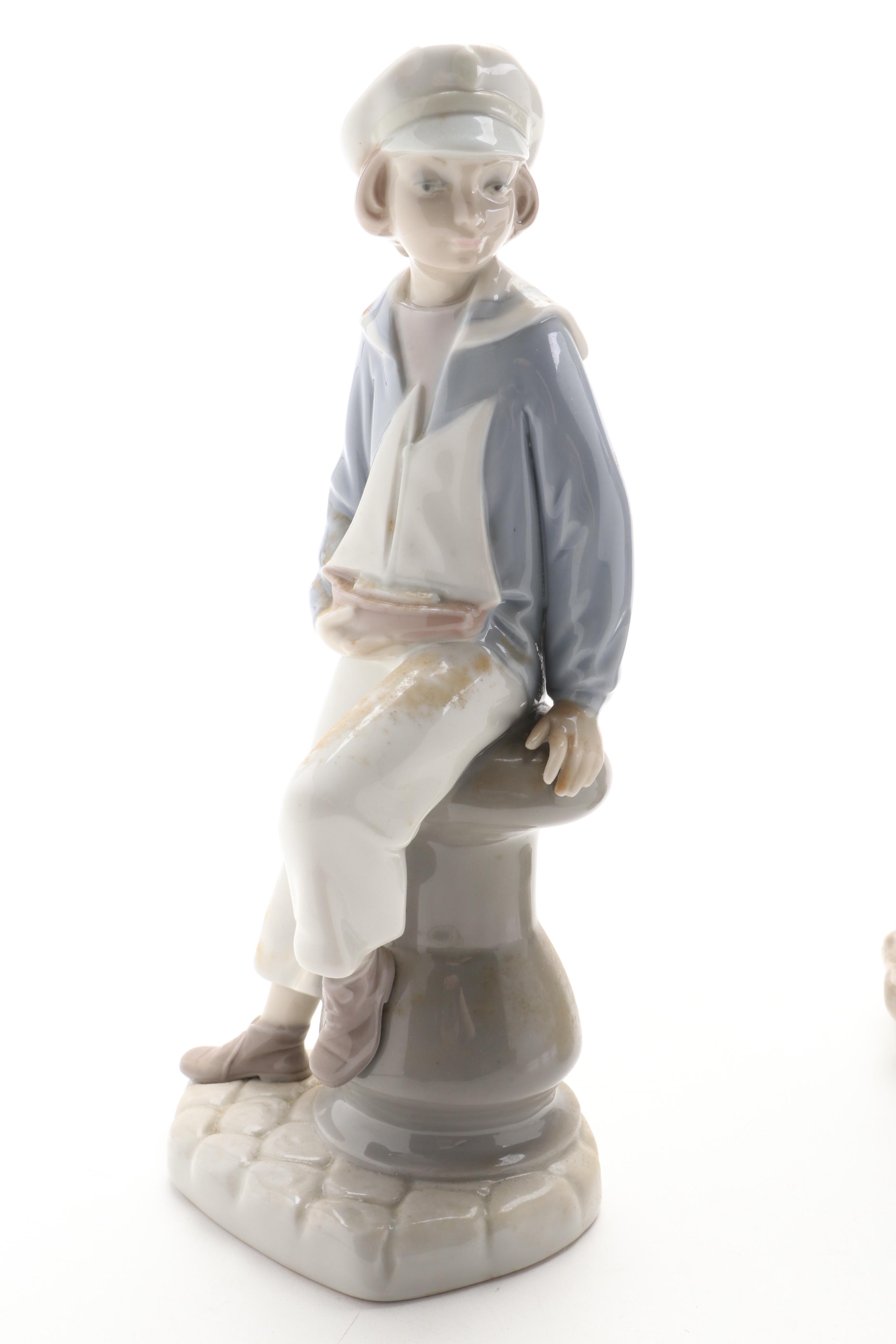 Royal Copenhagen Shephard Boy with Dog and Lladro Sailor Boy with Boat Figurines