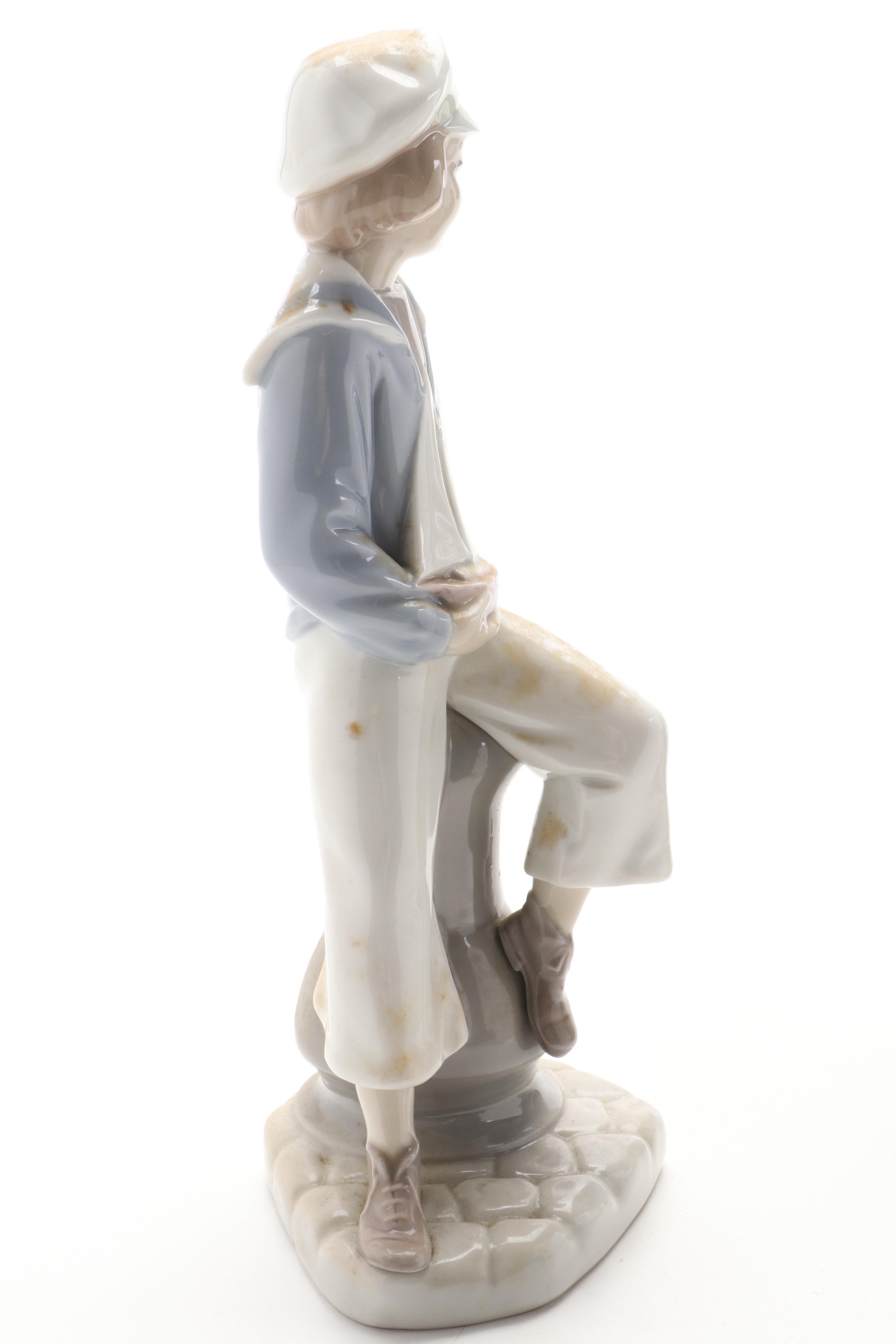 Royal Copenhagen Shephard Boy with Dog and Lladro Sailor Boy with Boat Figurines