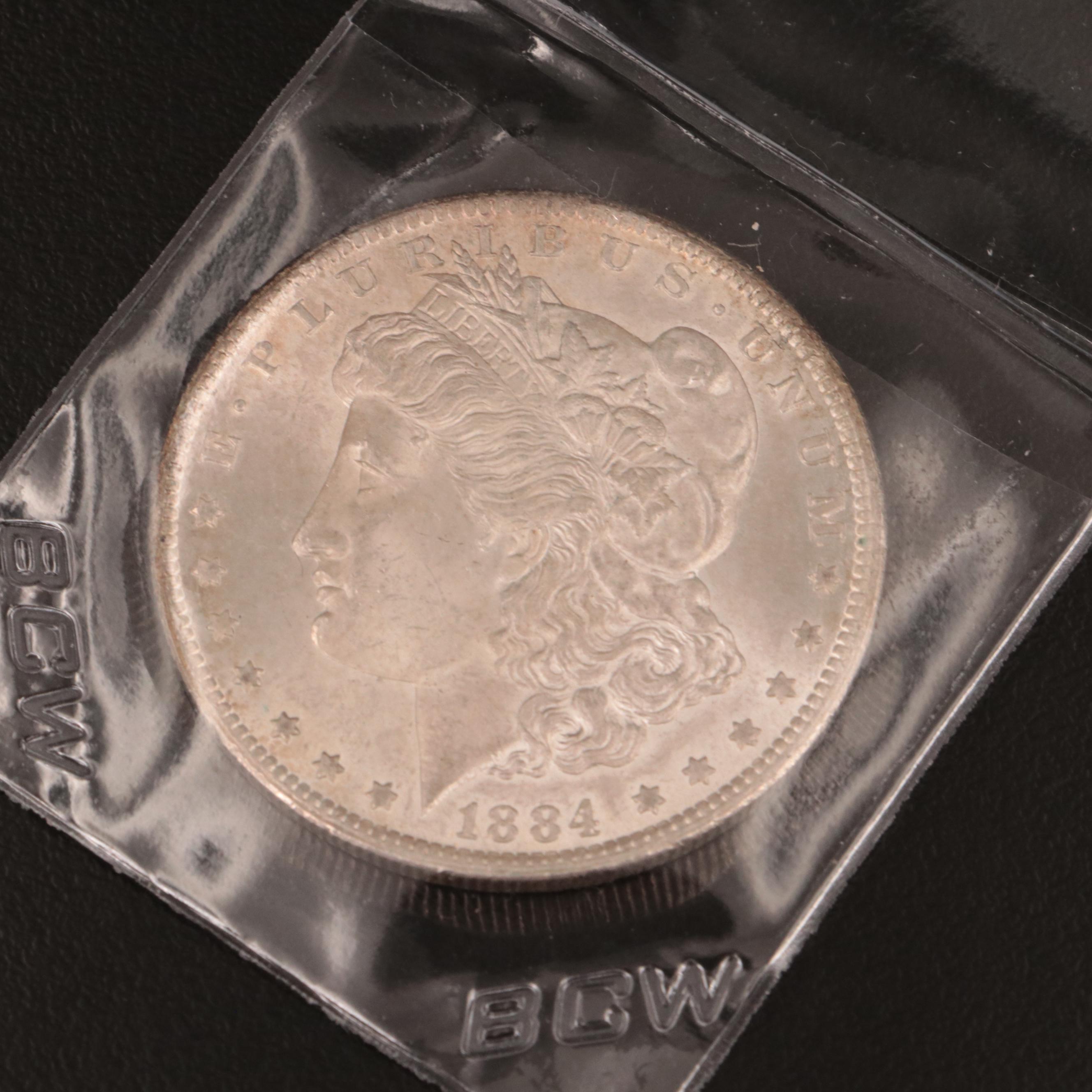 1884-CC Morgan Dollar and Thirty-Nine 1889 Morgan Dollars in Novelty Wrappers