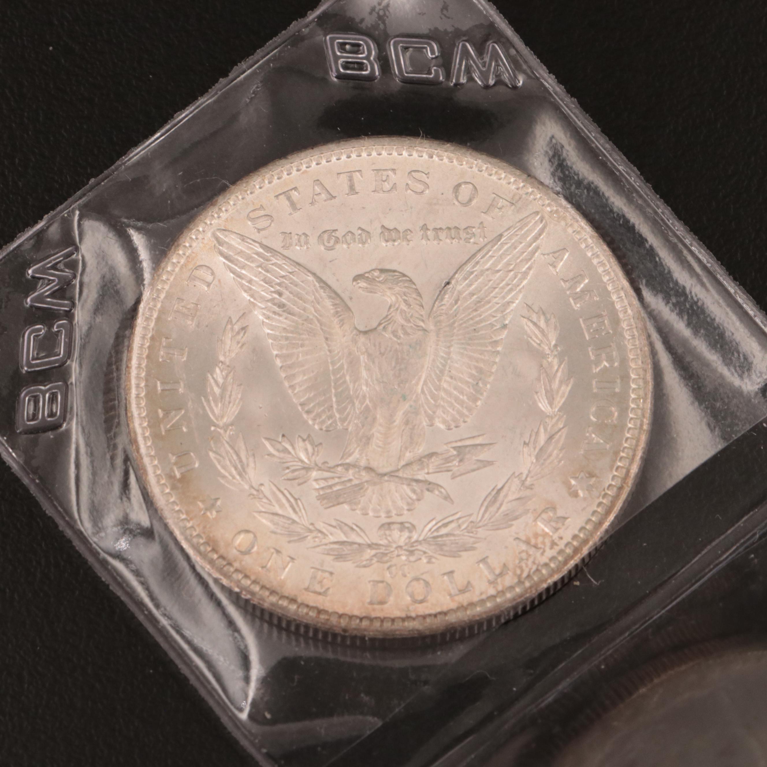 1884-CC Morgan Dollar and Thirty-Nine 1889 Morgan Dollars in Novelty Wrappers