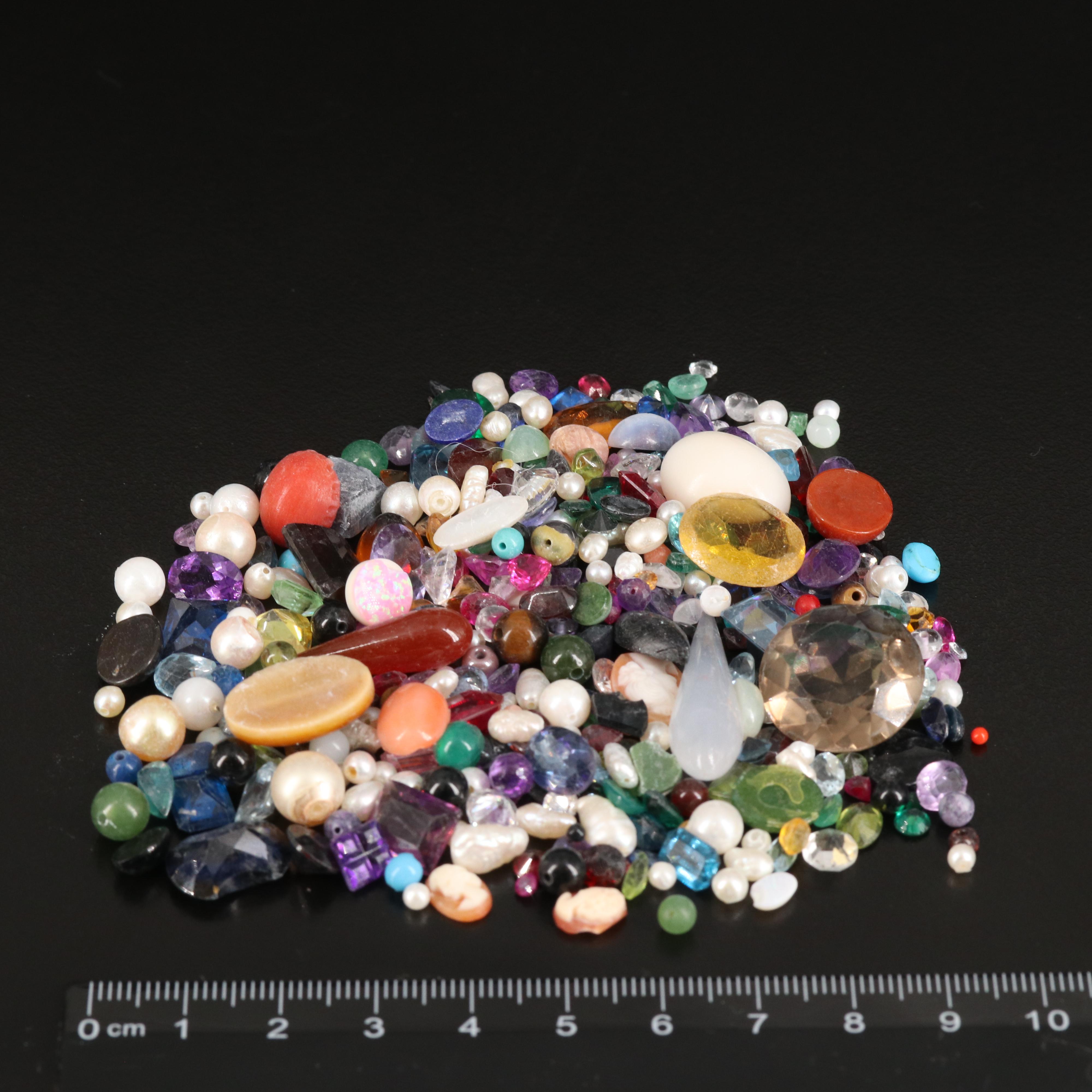 Loose Gemstones Including Smoky Quartz, Coral, and Pearl