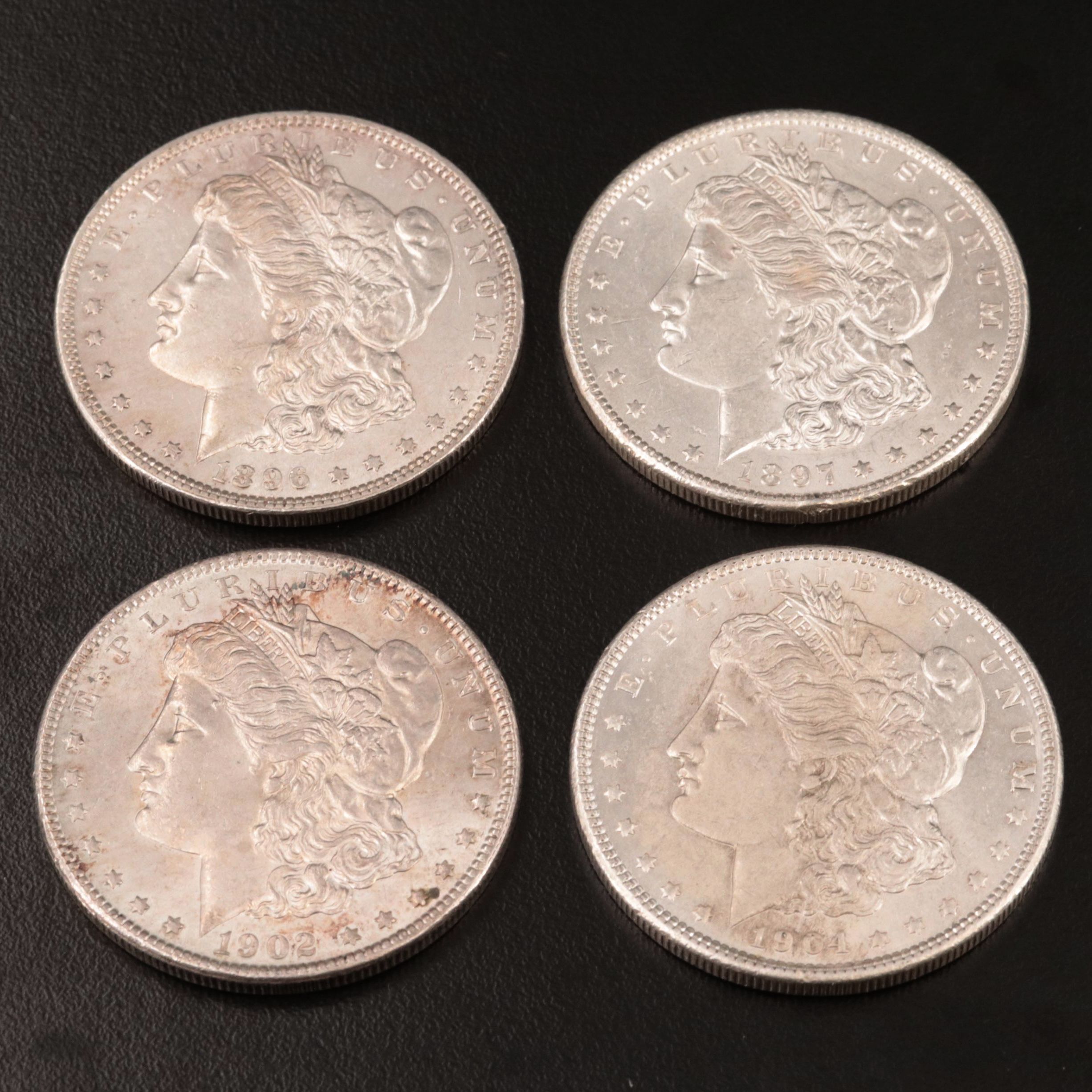Four Morgan Silver Dollars Including 1896
