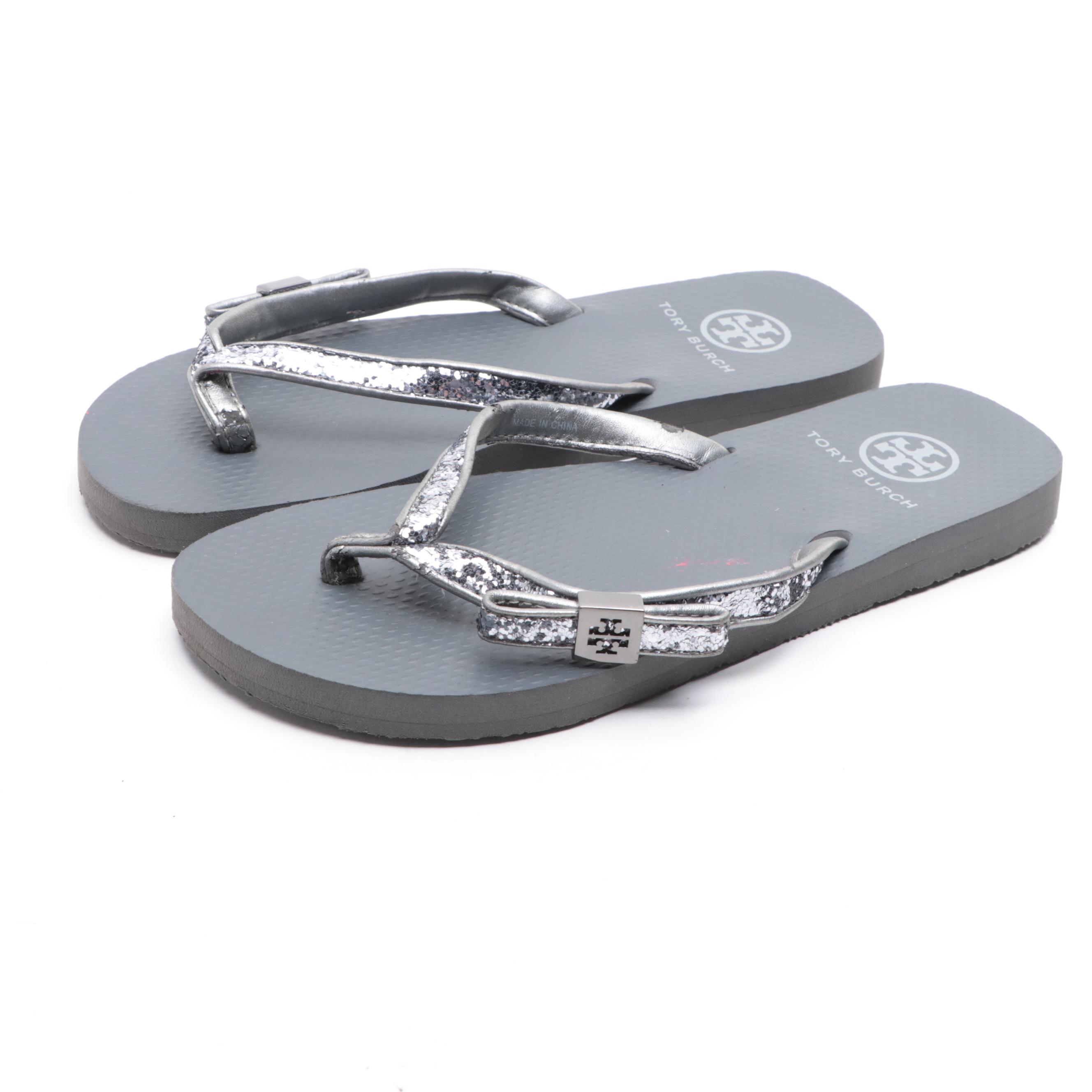 Stuart Weitzman Embossed Leather Loafers and Tory Burch Flip-Flops