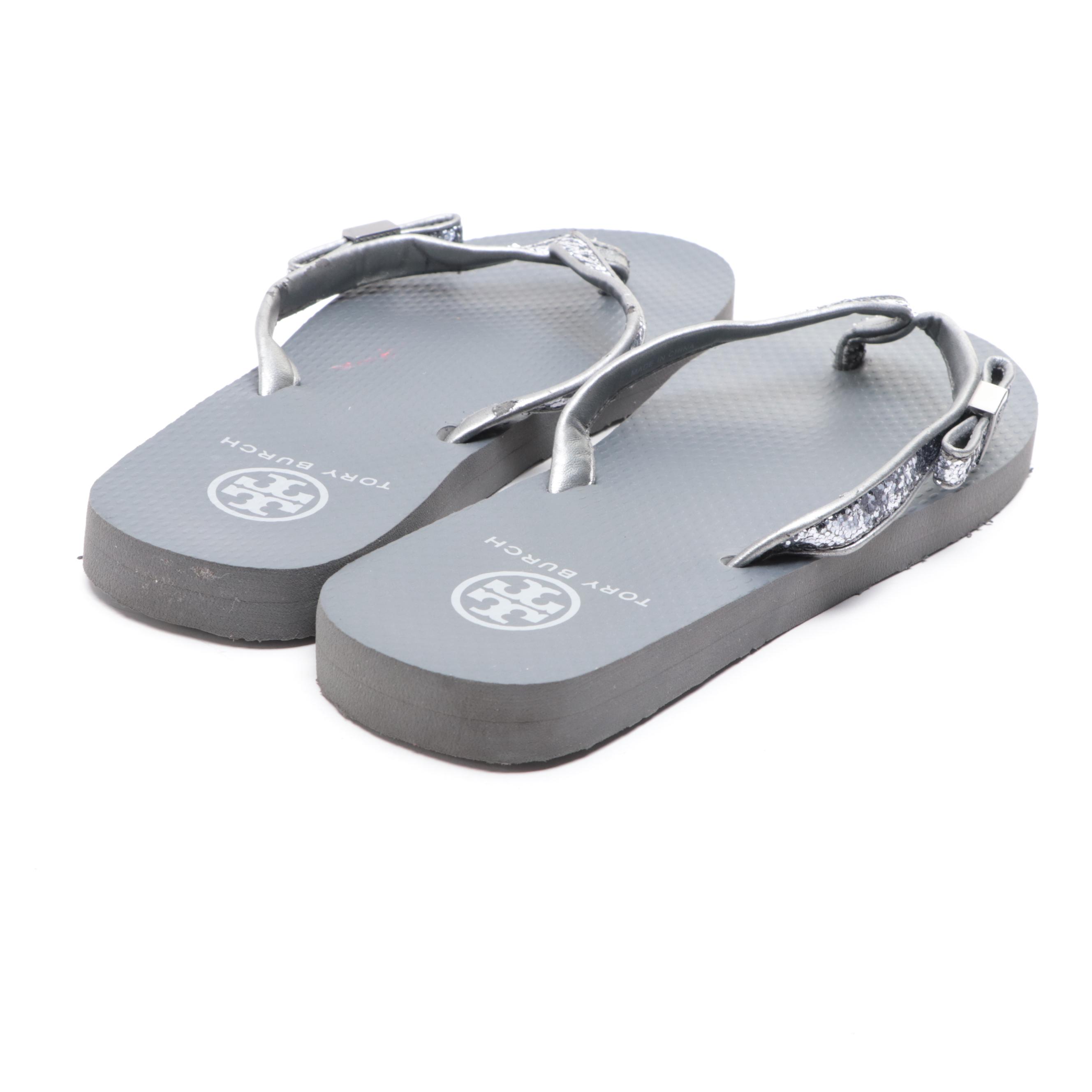 Stuart Weitzman Embossed Leather Loafers and Tory Burch Flip-Flops