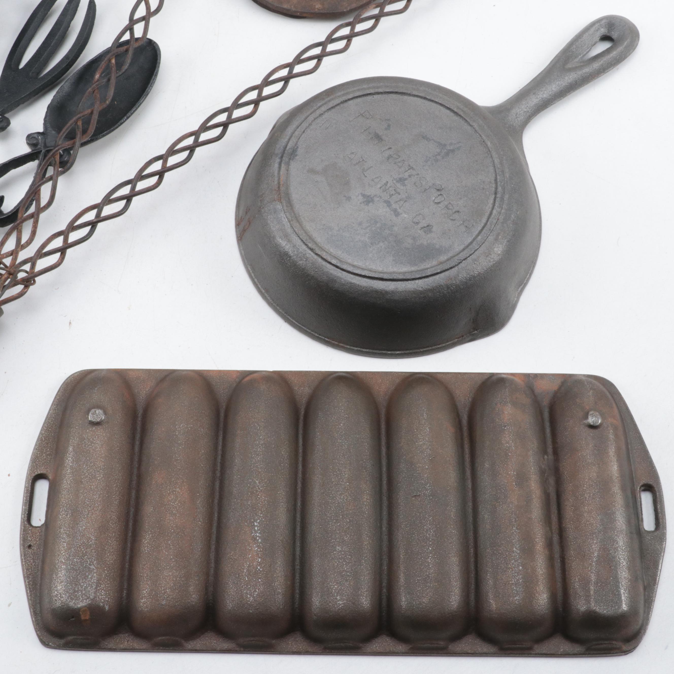 Cast Iron Lidded Pot, Cornbread Pan, Skillet, Rug Beater, Ice Tongs, and More