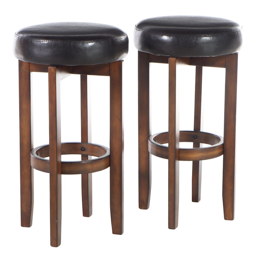 Pair of Ashley Furniture Hardwood and Faux-Leather Swivel Bar Stools