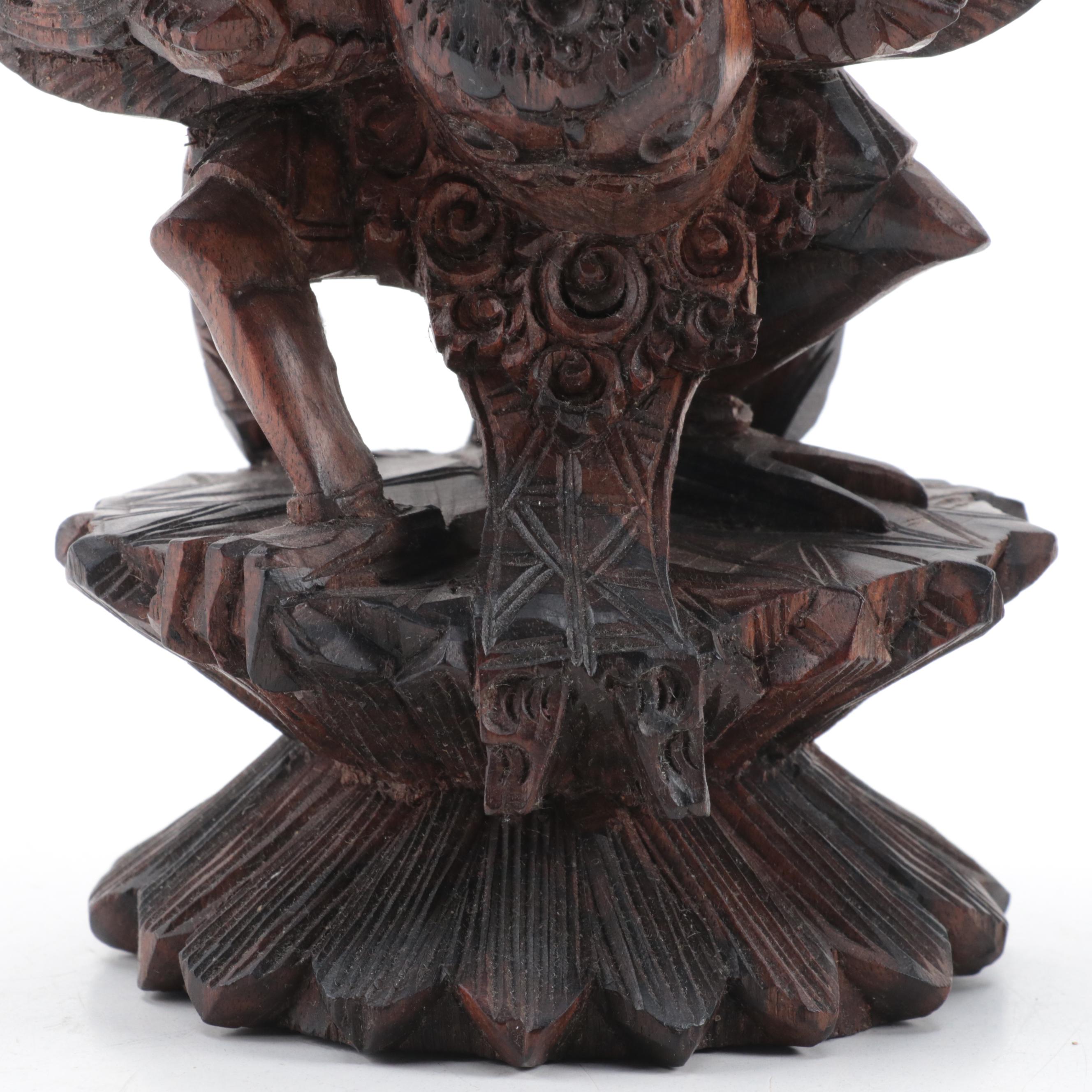 Indonesian Carved Wood Cili Masks and Vishnu Riding Garuda Sculptures