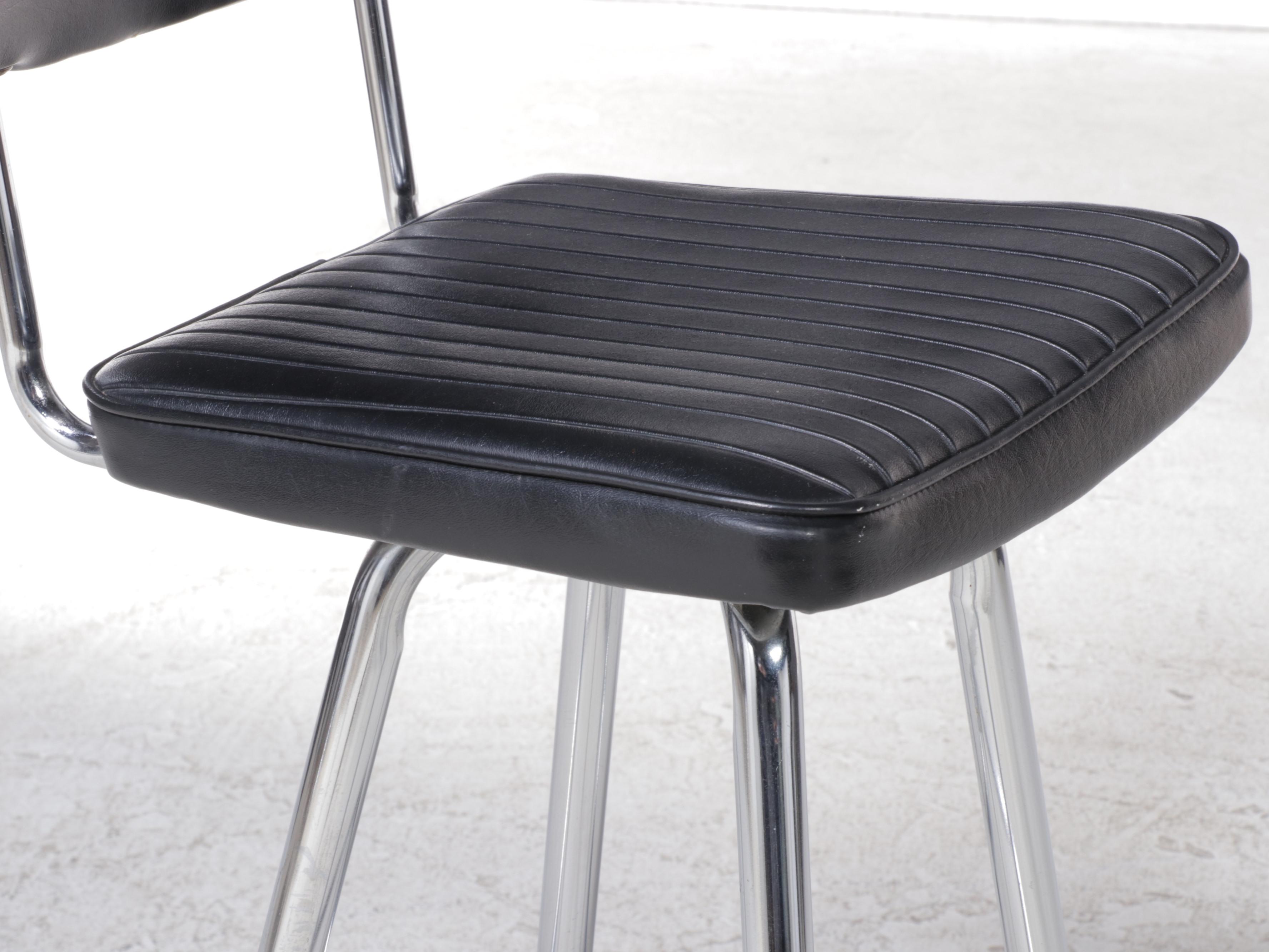 Four Chromcraft Modernist Chromed Steel and Black Vinyl Swivel Bar Stools