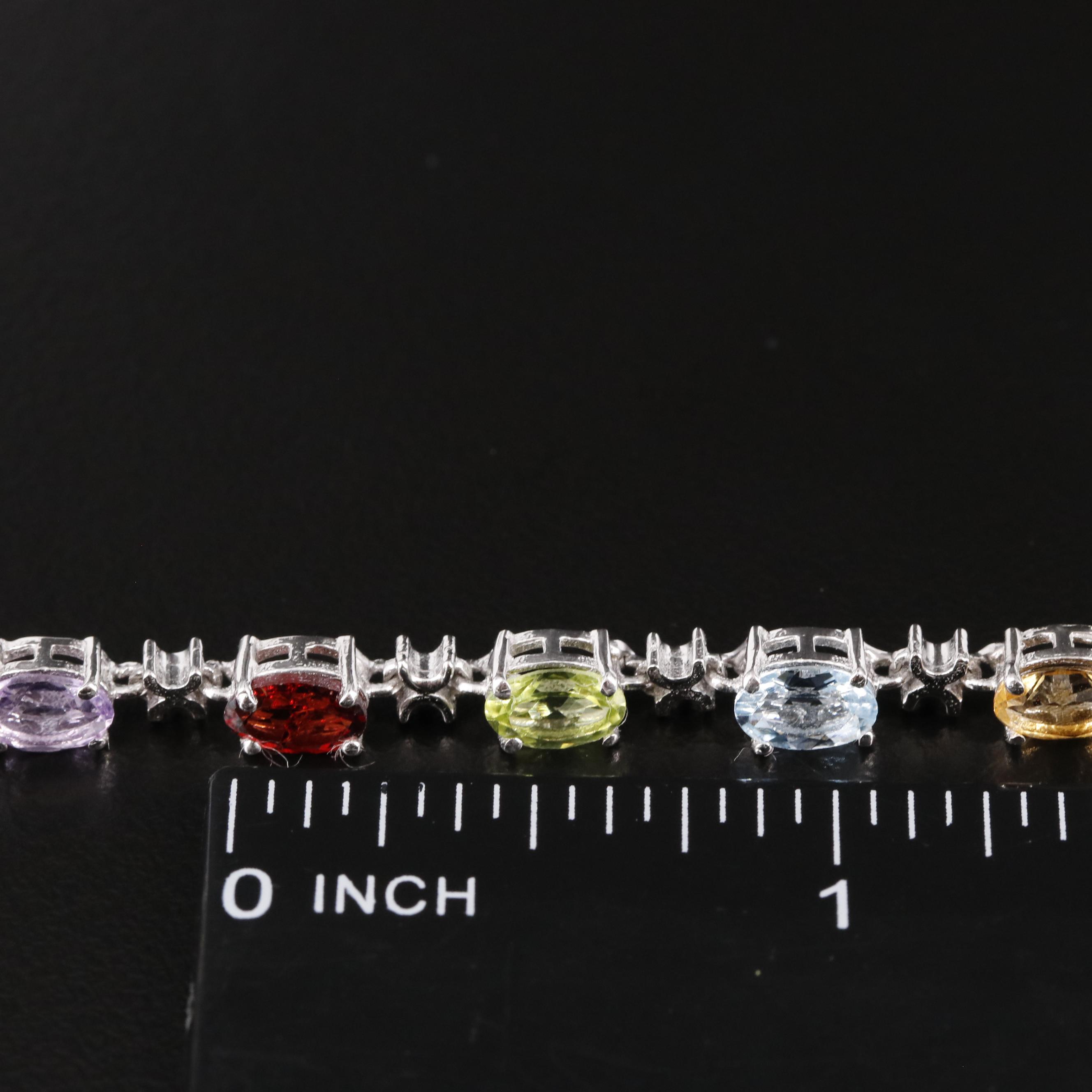 Sterling Amethyst, Blue Topaz, and Rhodelite Garnet Tennis Bracelet