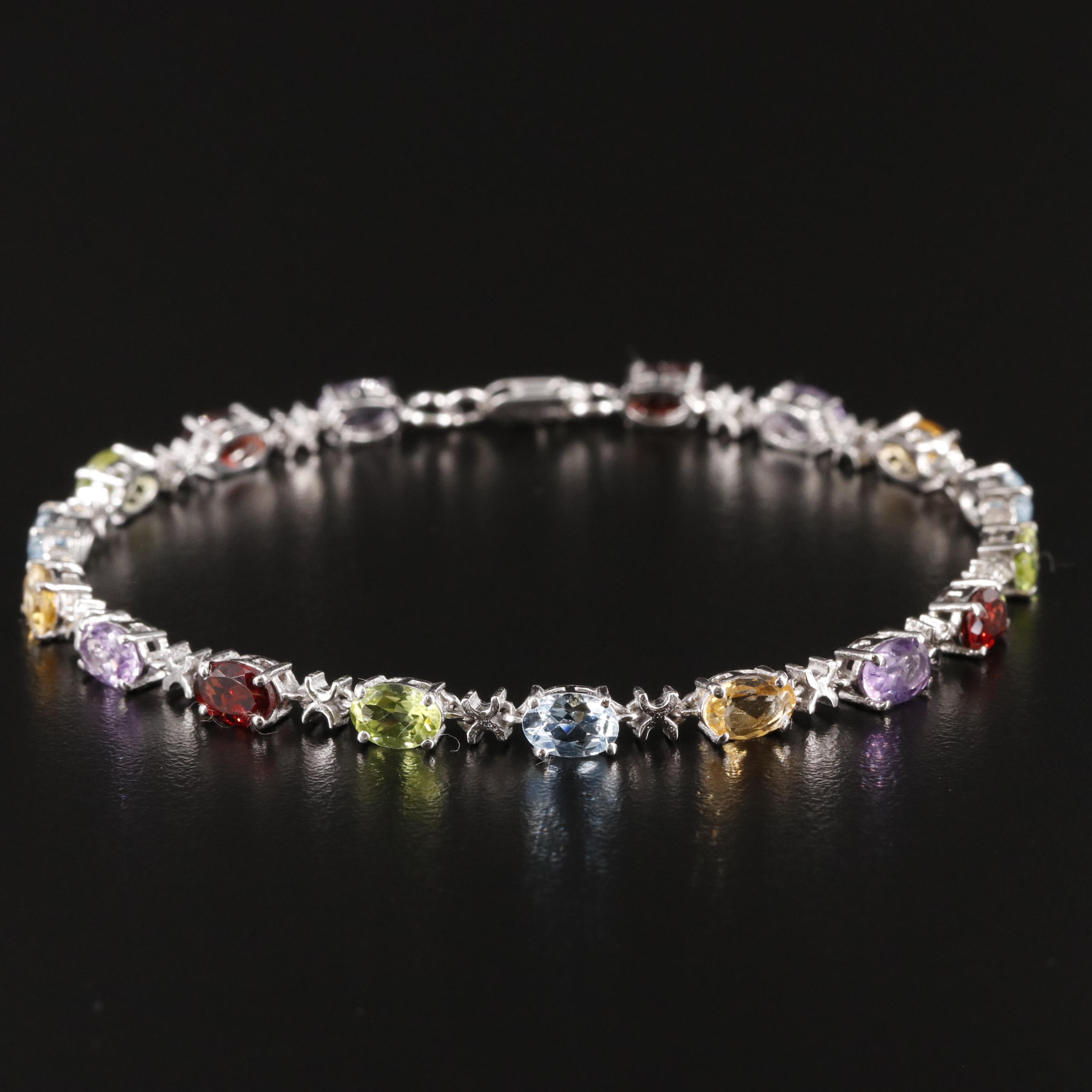 Sterling Amethyst, Blue Topaz, and Rhodelite Garnet Tennis Bracelet