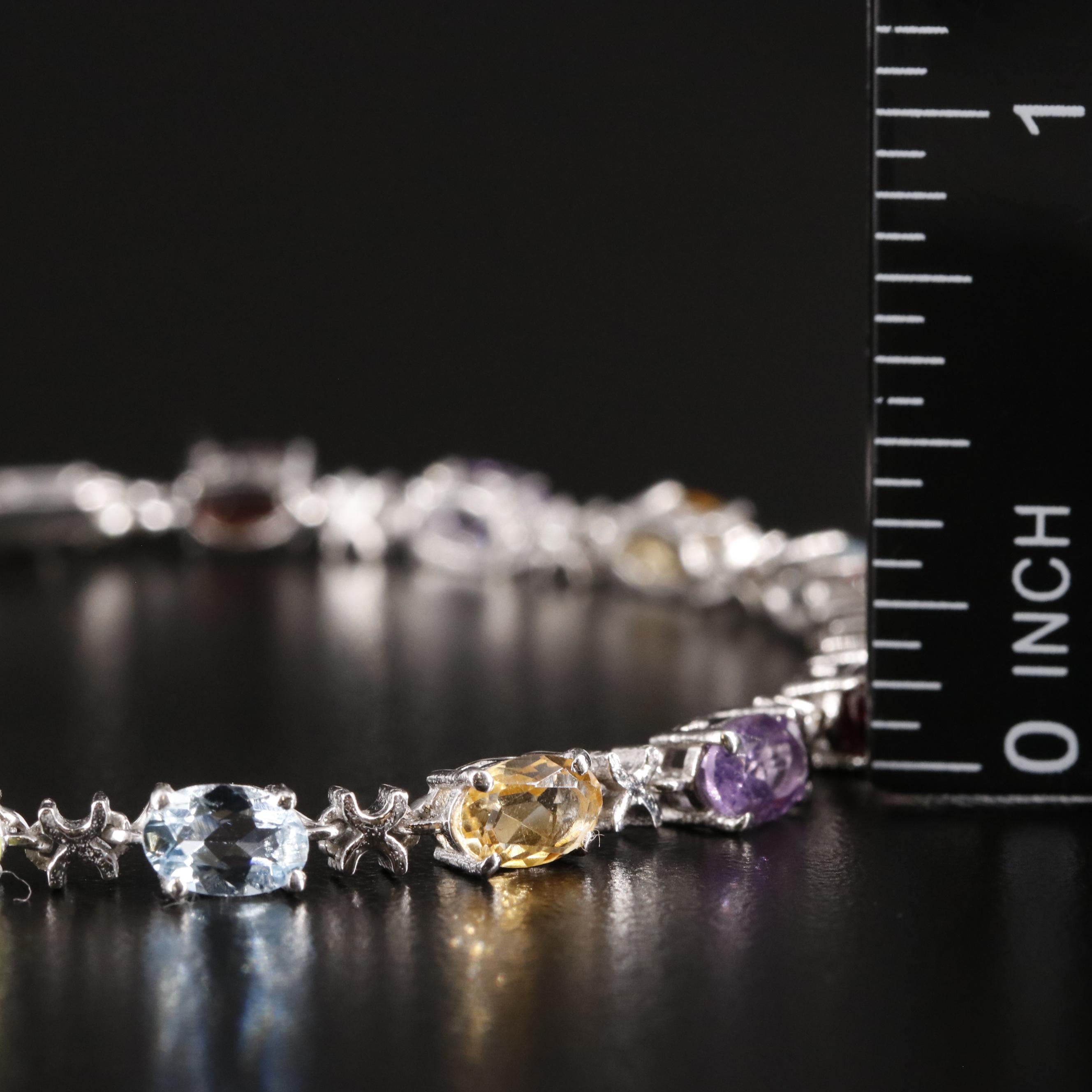 Sterling Amethyst, Blue Topaz, and Rhodelite Garnet Tennis Bracelet