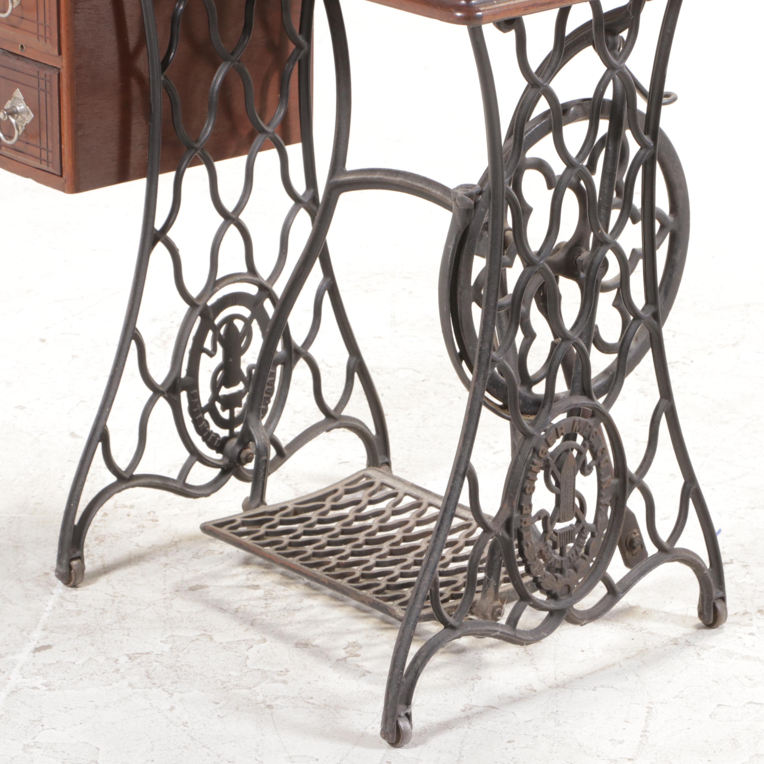 The Singer Mfg. Co. Walnut and Cast Iron Treadle-Base Sewing Machine