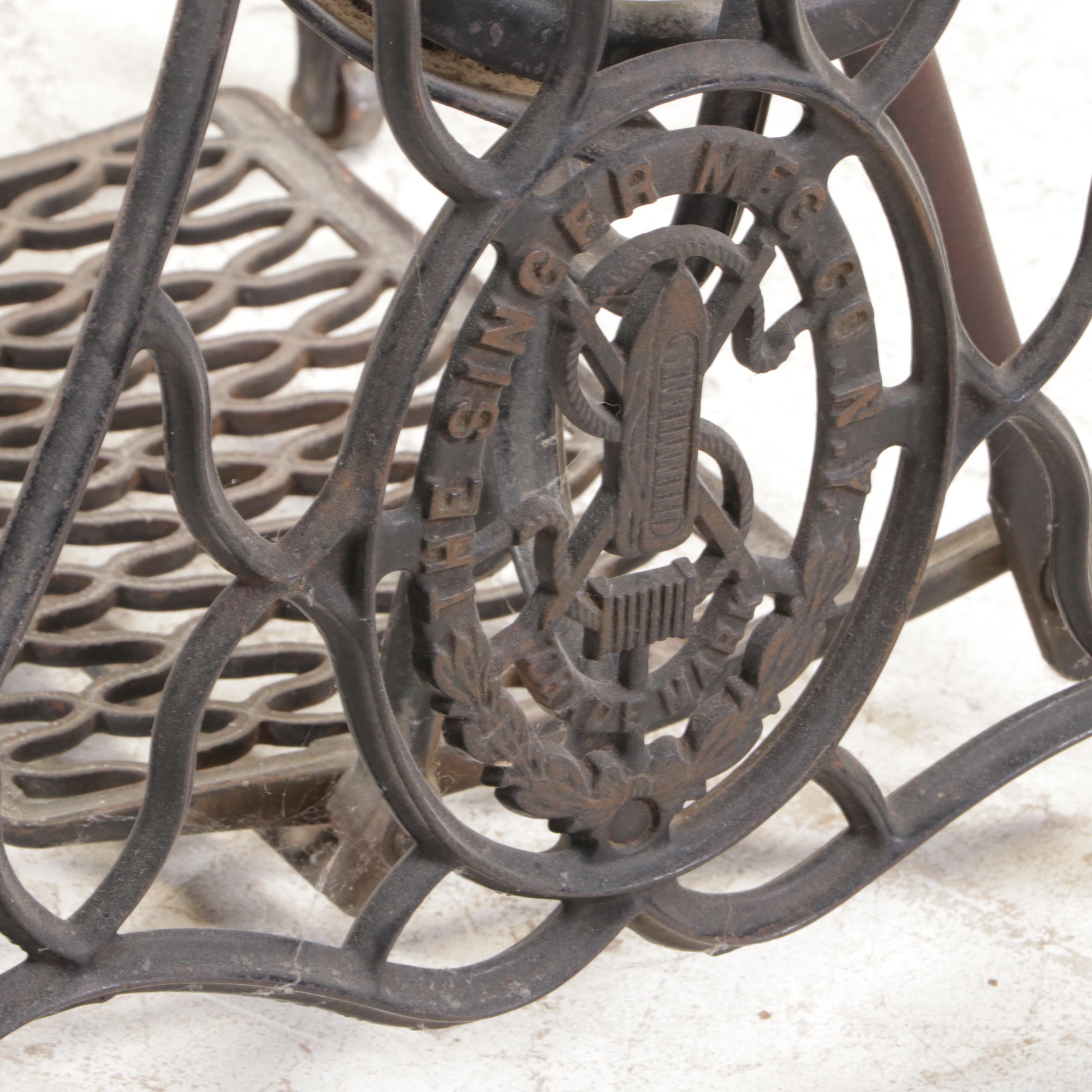 The Singer Mfg. Co. Walnut and Cast Iron Treadle-Base Sewing Machine