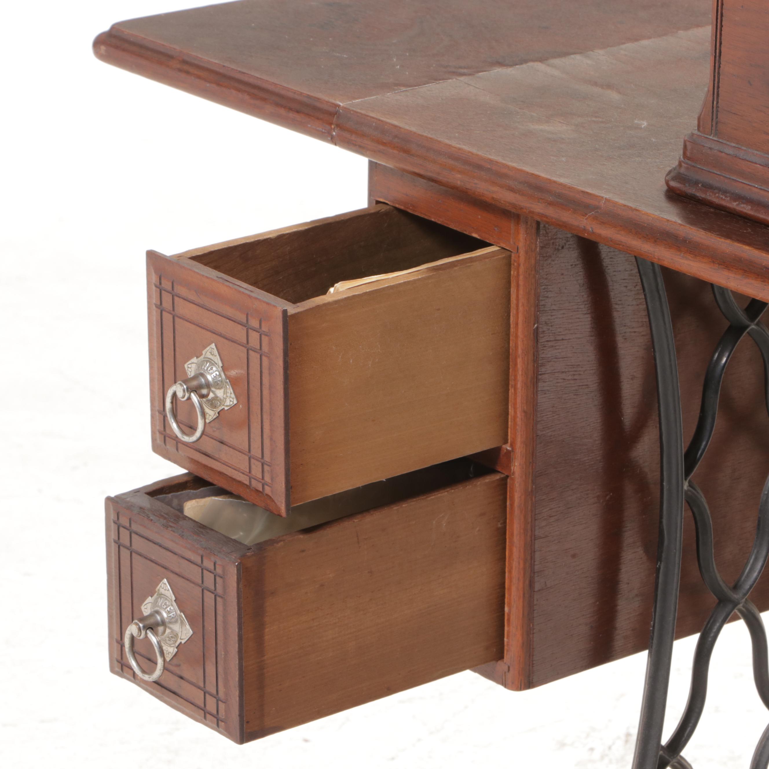 The Singer Mfg. Co. Walnut and Cast Iron Treadle-Base Sewing Machine