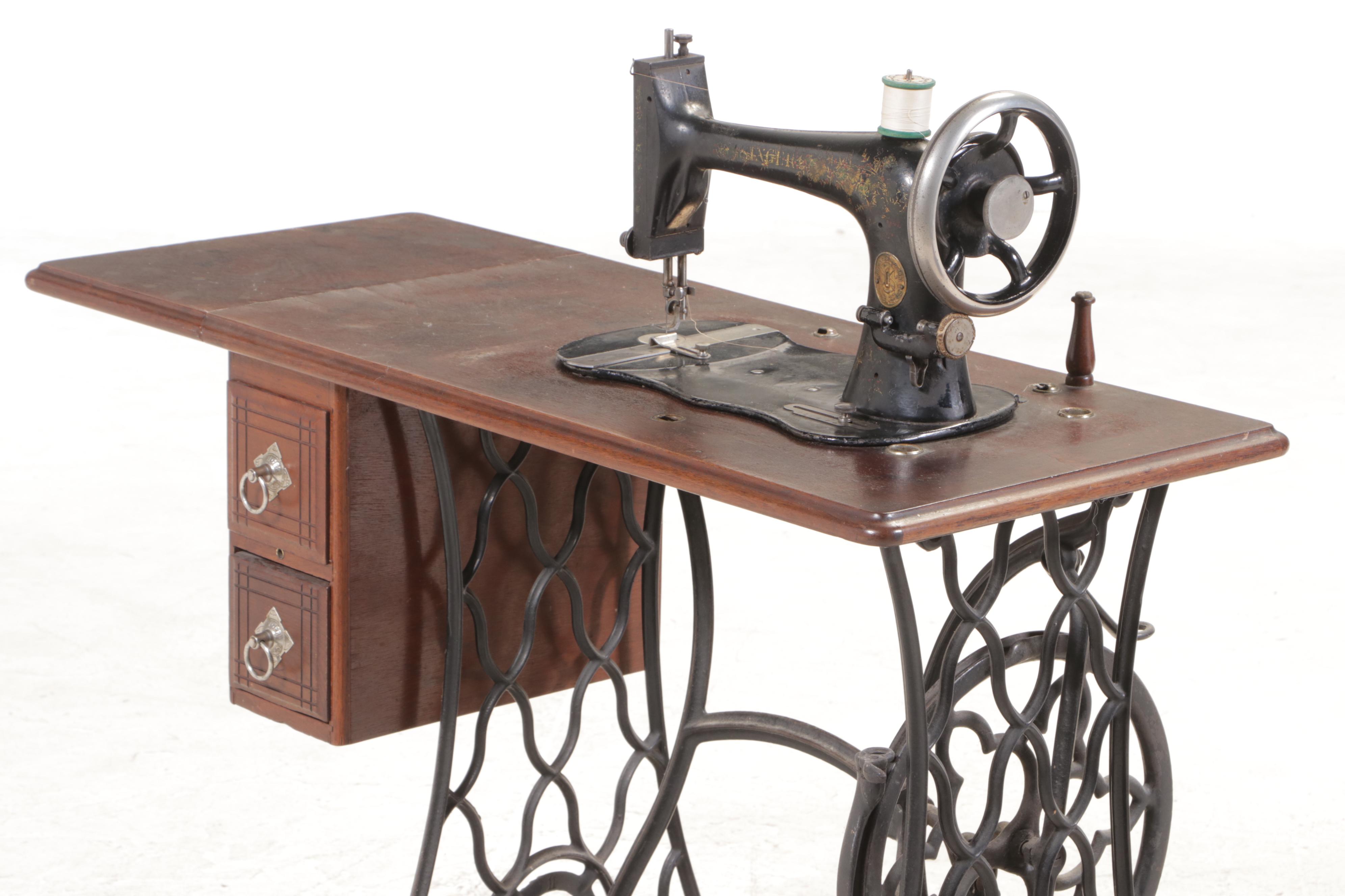 The Singer Mfg. Co. Walnut and Cast Iron Treadle-Base Sewing Machine