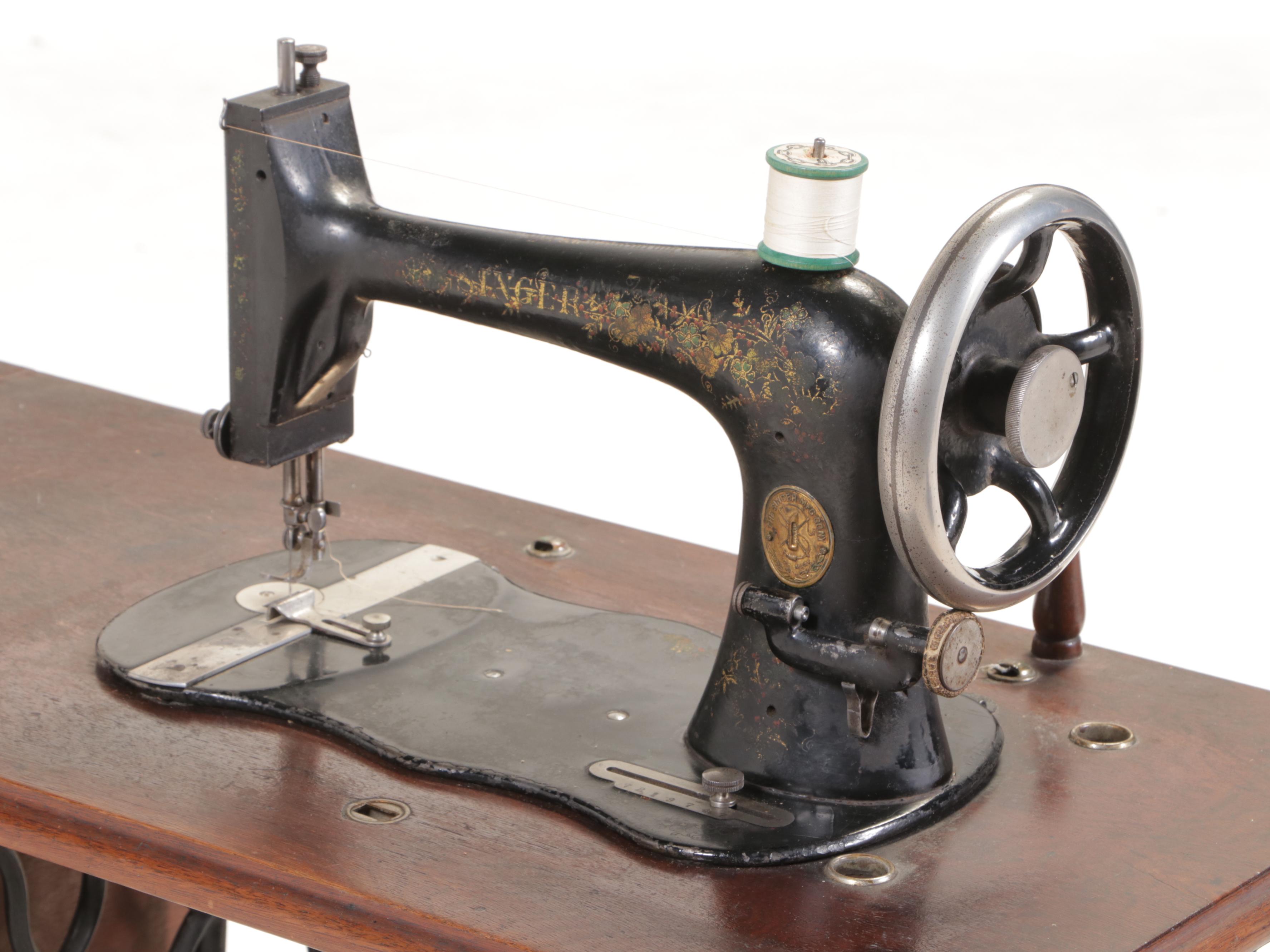 The Singer Mfg. Co. Walnut and Cast Iron Treadle-Base Sewing Machine