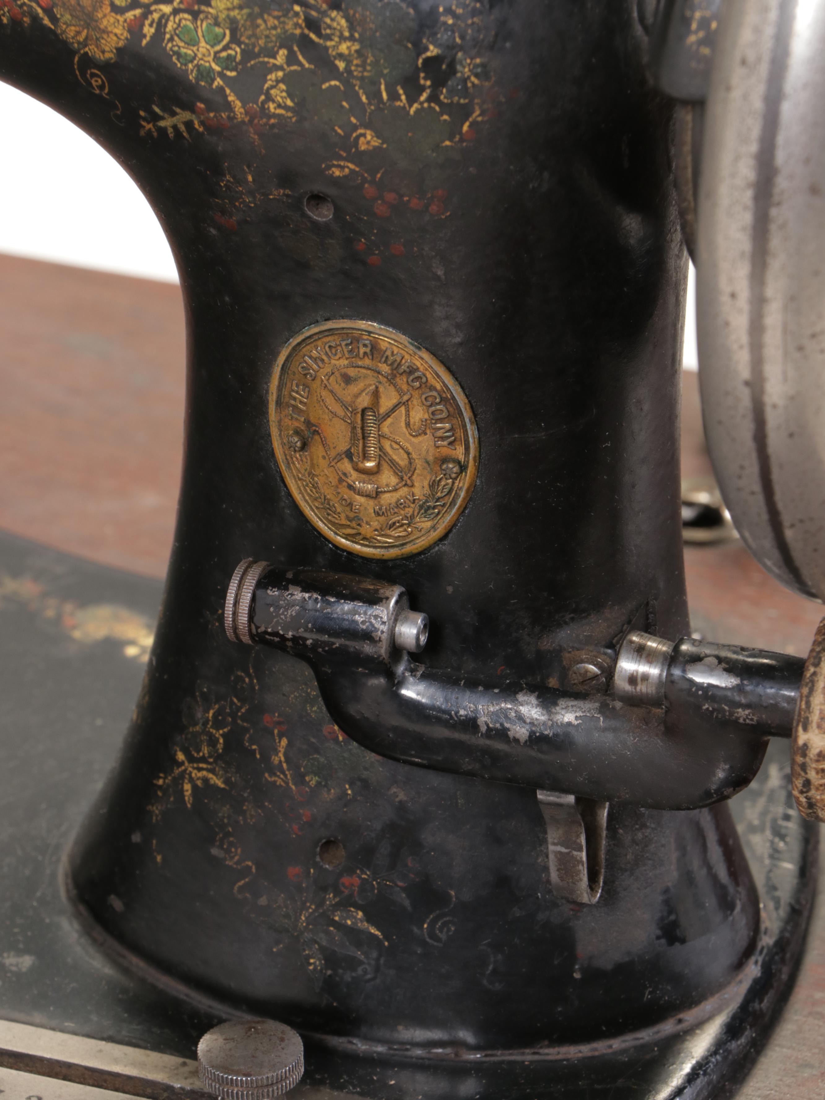 The Singer Mfg. Co. Walnut and Cast Iron Treadle-Base Sewing Machine