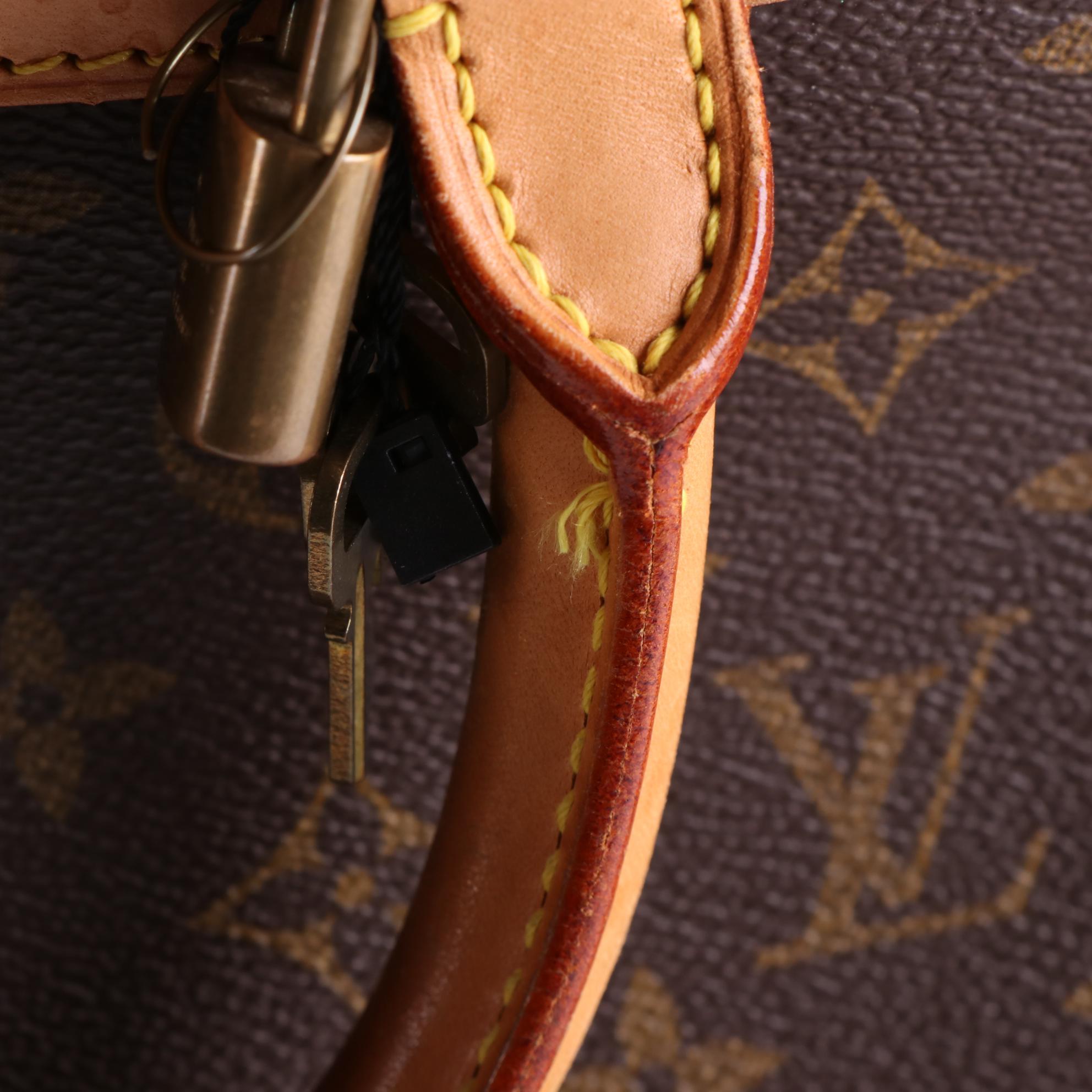 Louis Vuitton Evasion MM Travel Bag in Monogram Canvas and Vachetta Leather