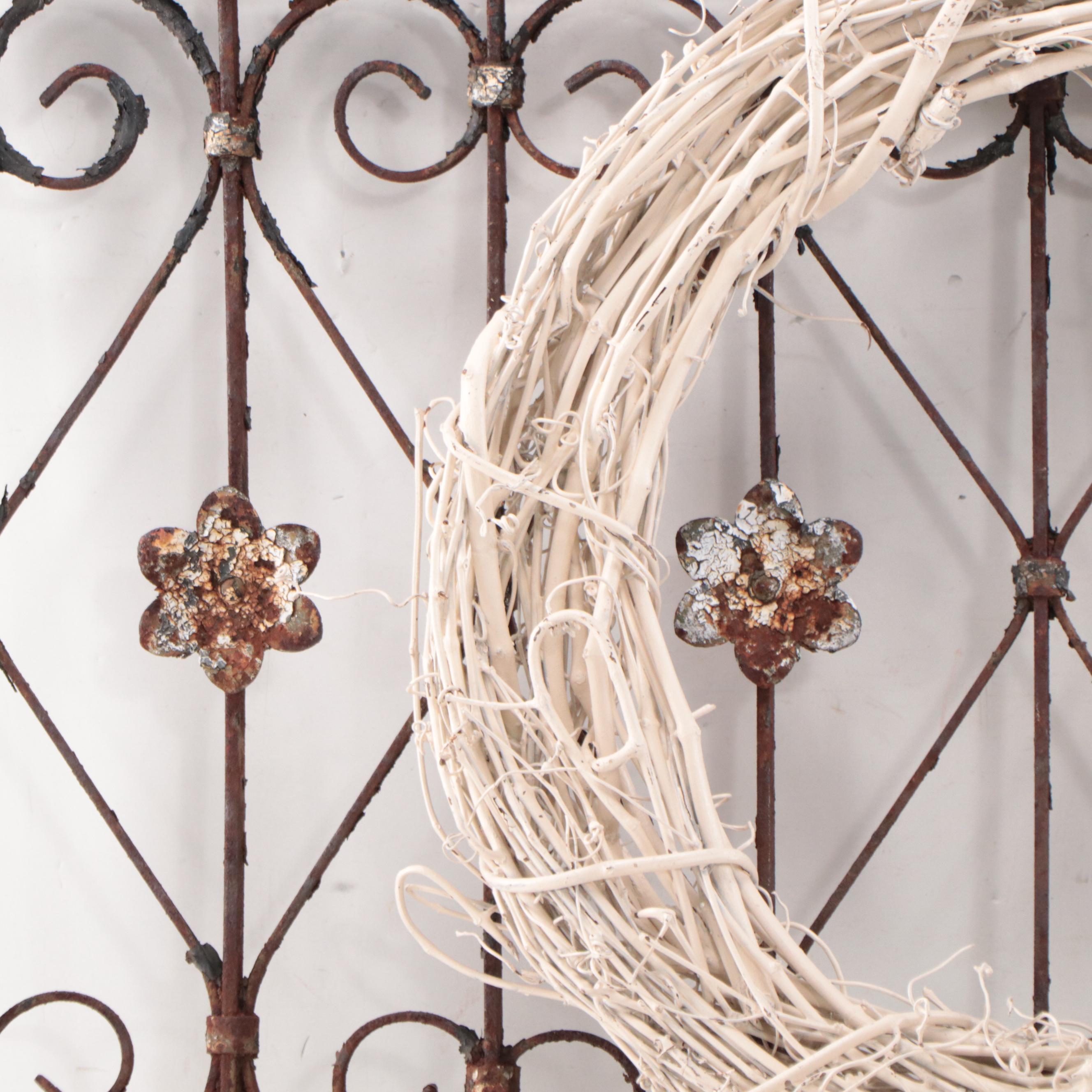 Wrought Iron Fencing With Wreath and Metal Pitcher