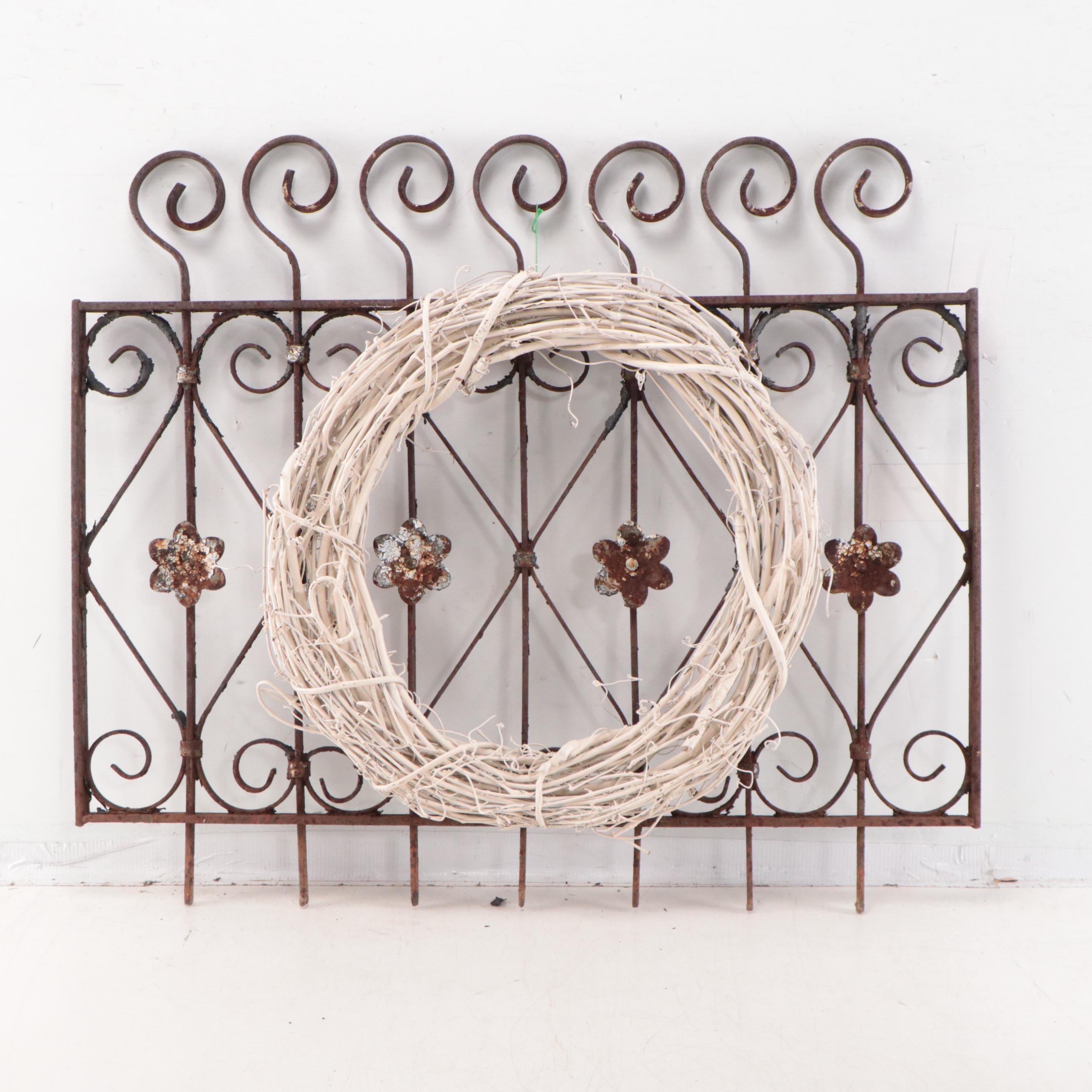 Wrought Iron Fencing With Wreath and Metal Pitcher