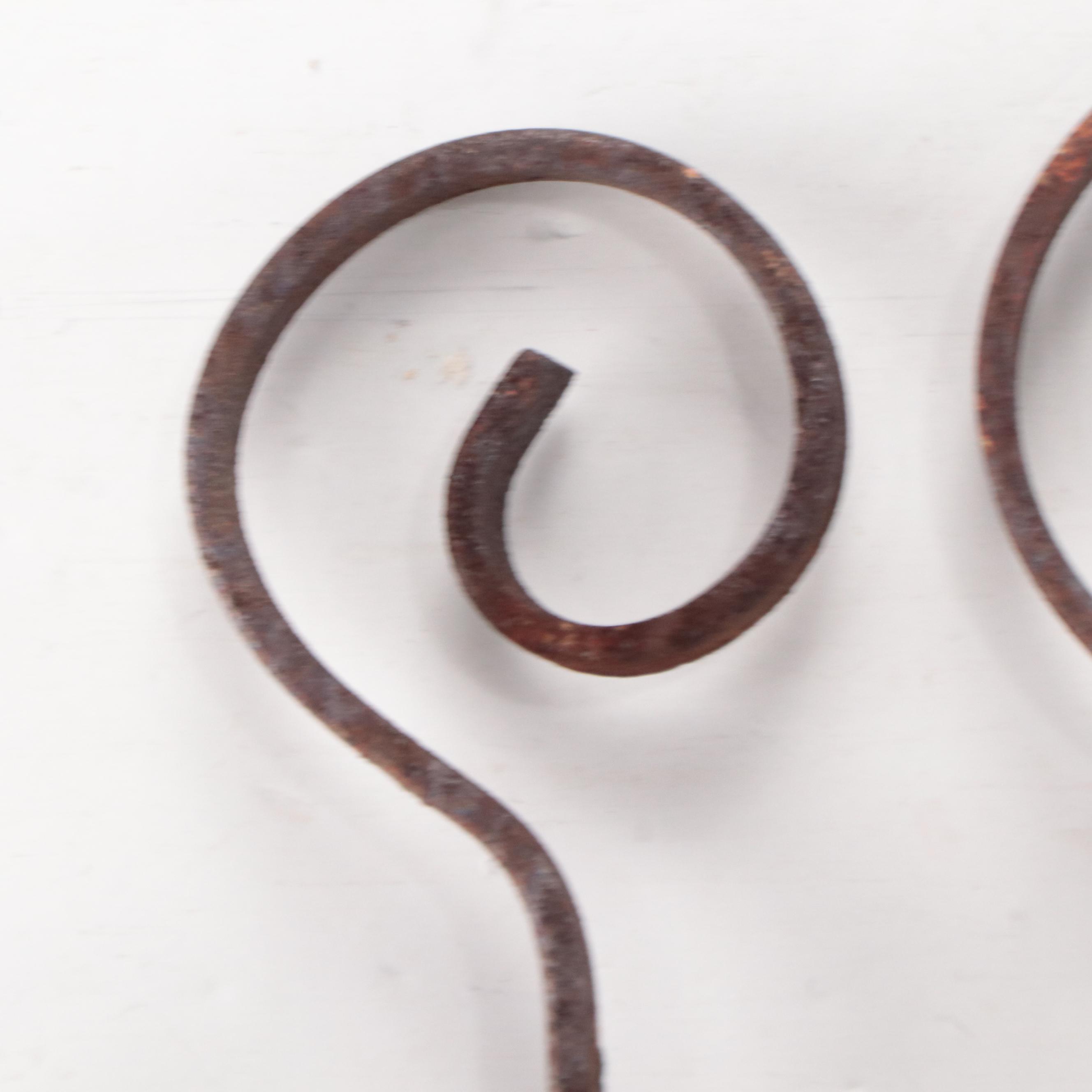 Wrought Iron Fencing With Wreath and Metal Pitcher