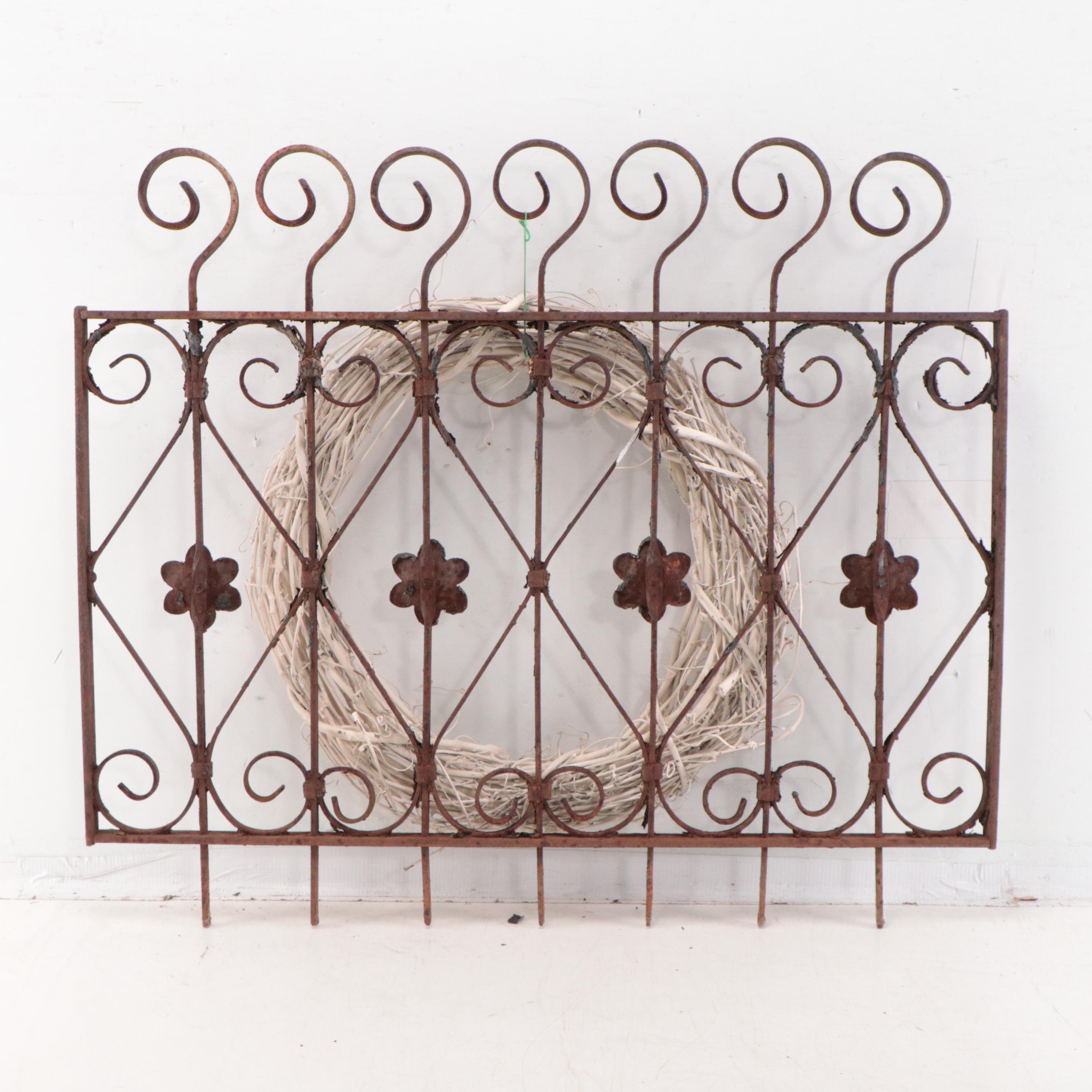 Wrought Iron Fencing With Wreath and Metal Pitcher
