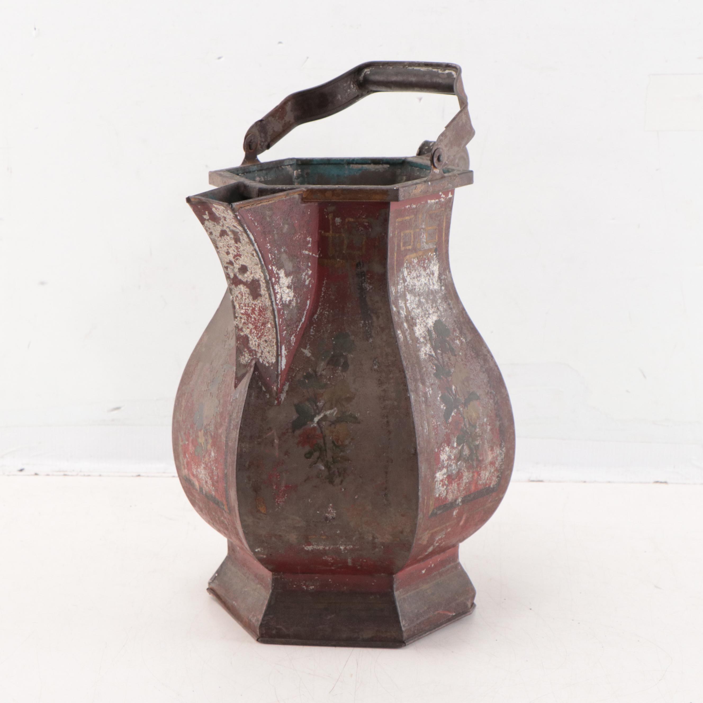 Wrought Iron Fencing With Wreath and Metal Pitcher