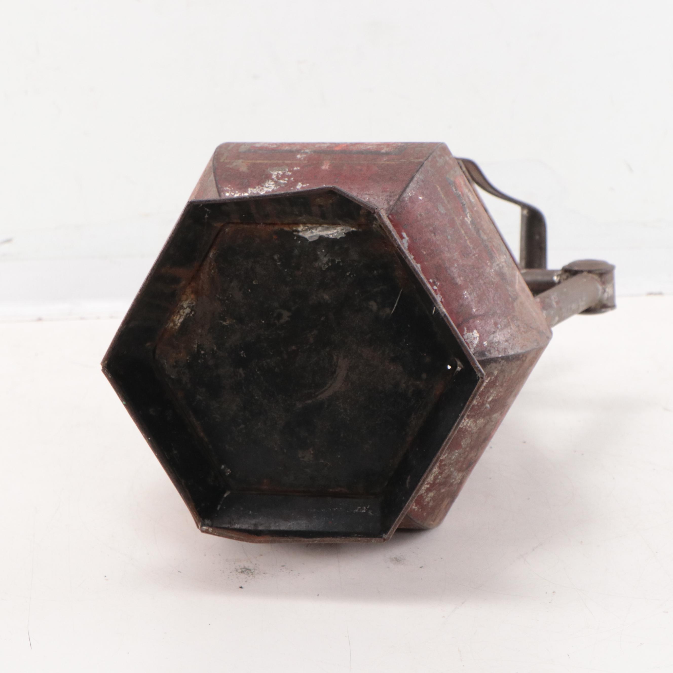 Wrought Iron Fencing With Wreath and Metal Pitcher