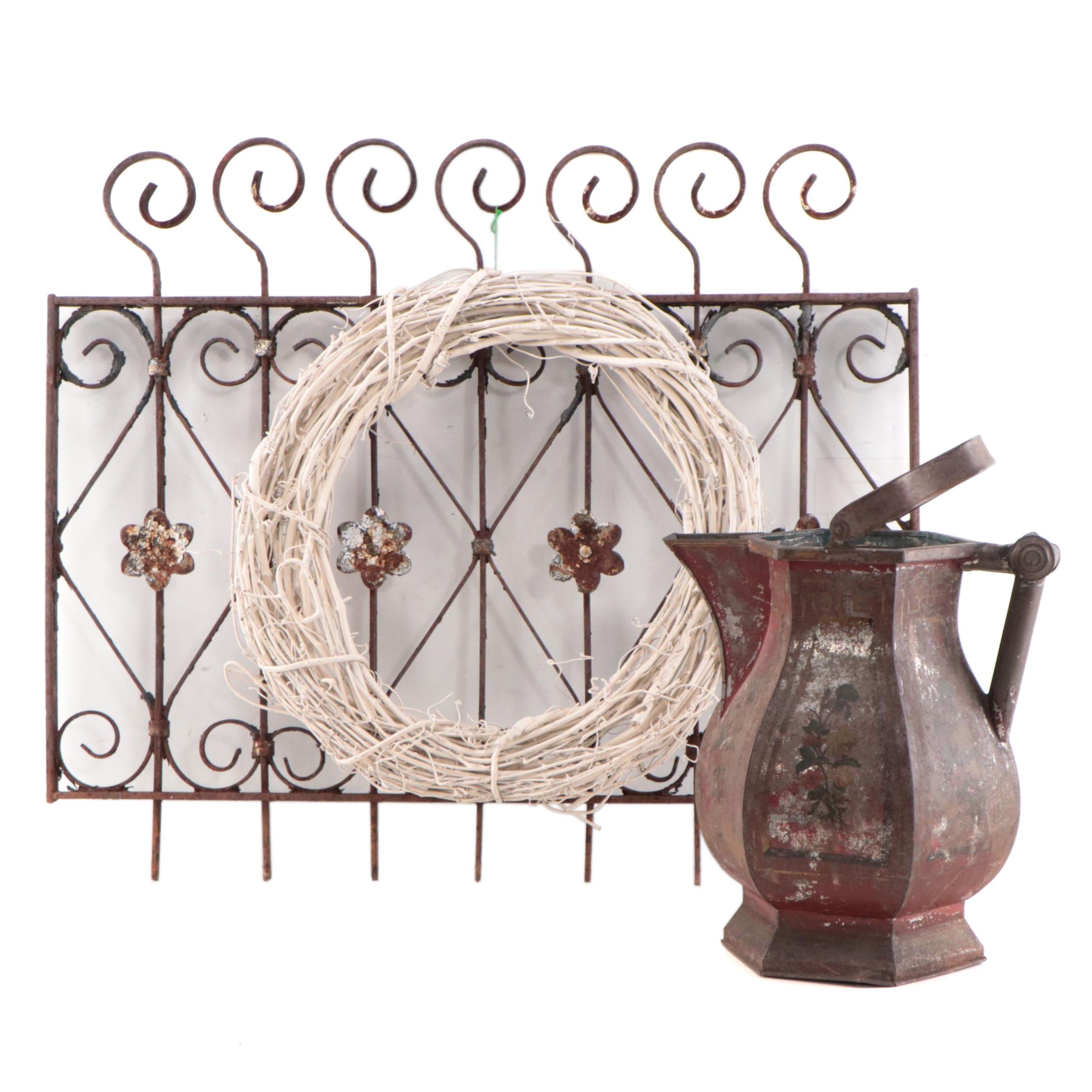 Wrought Iron Fencing With Wreath and Metal Pitcher