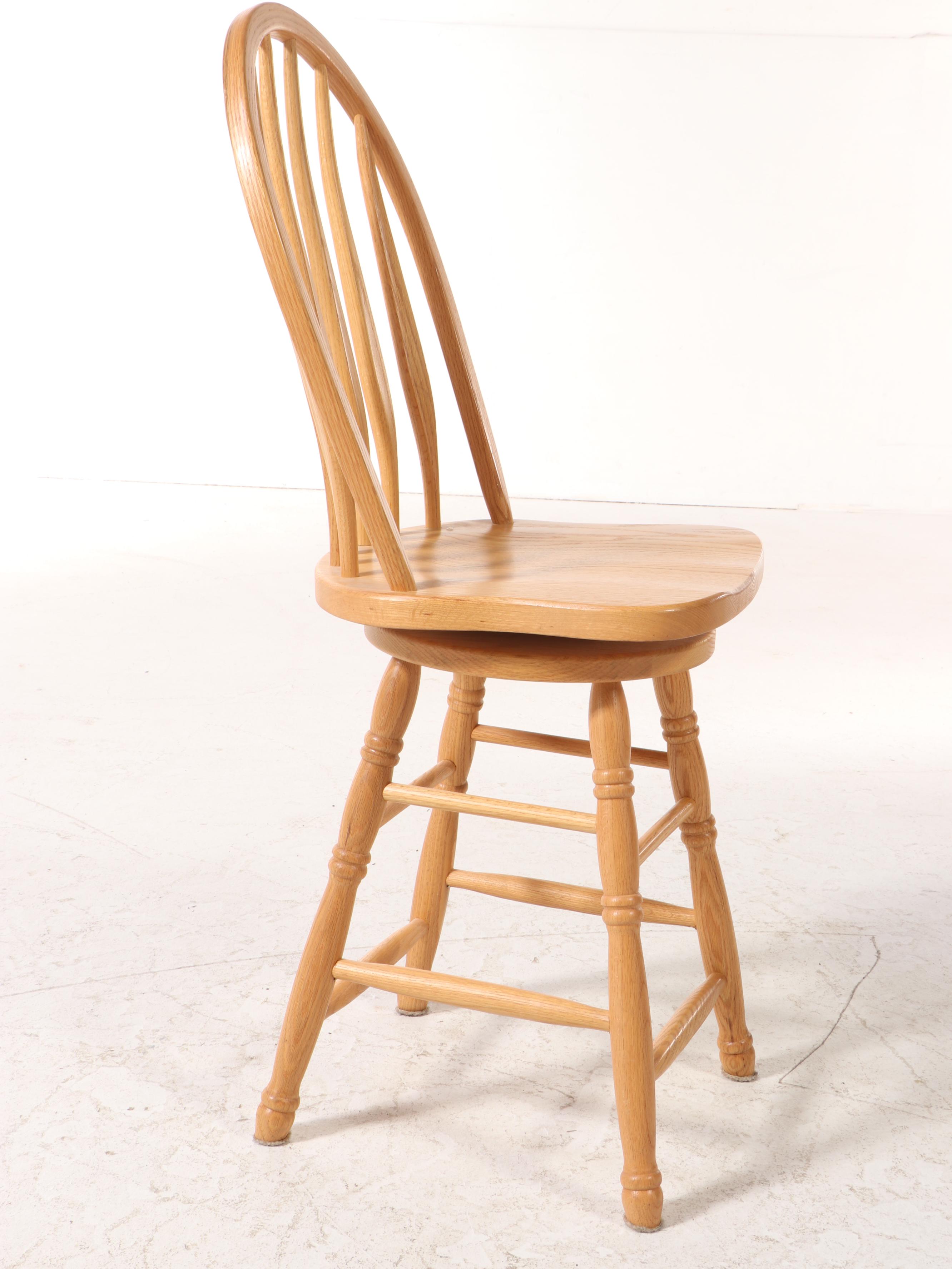 Four American Colonial Style Oak Swivel Windsor Counter Stools