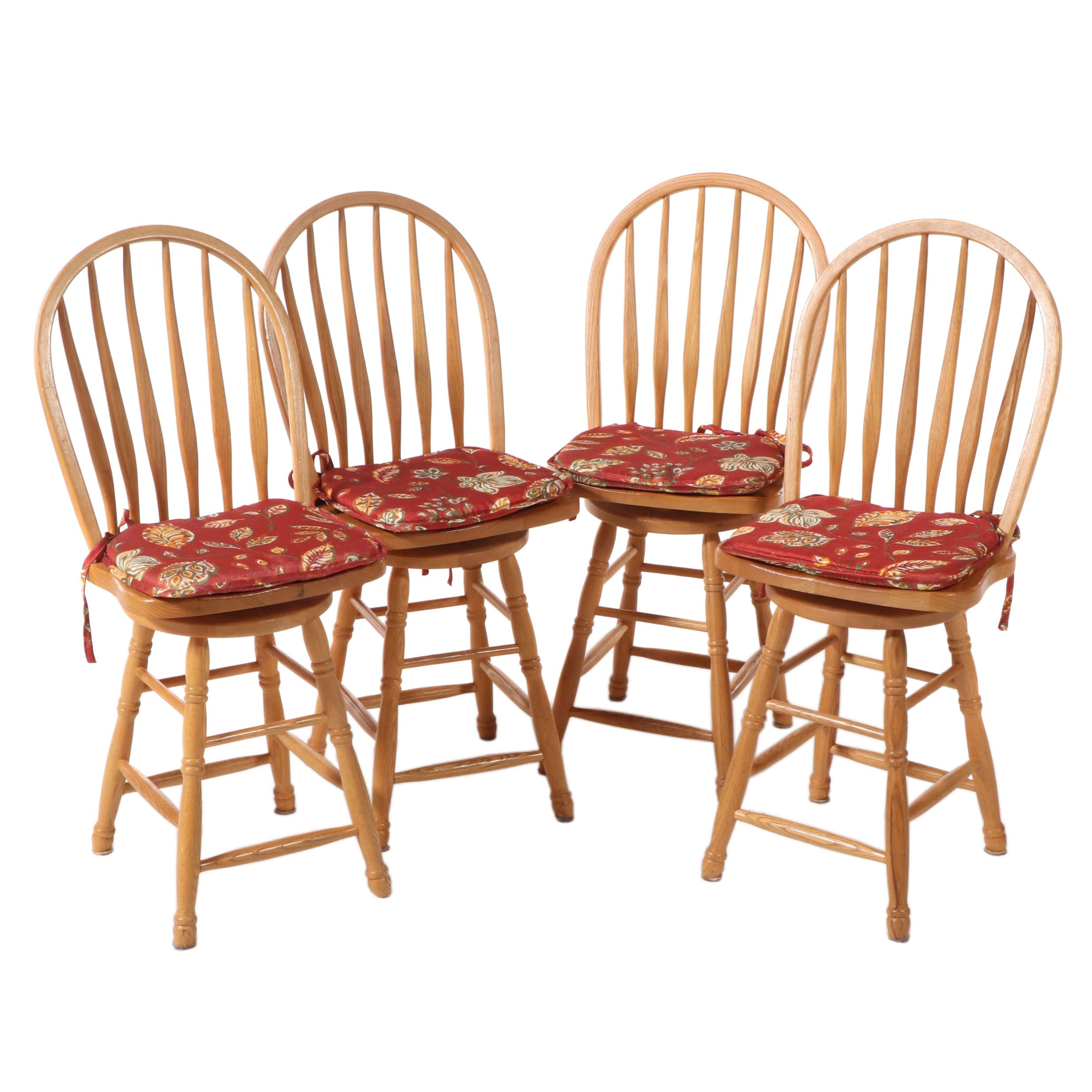 Four American Colonial Style Oak Swivel Windsor Counter Stools