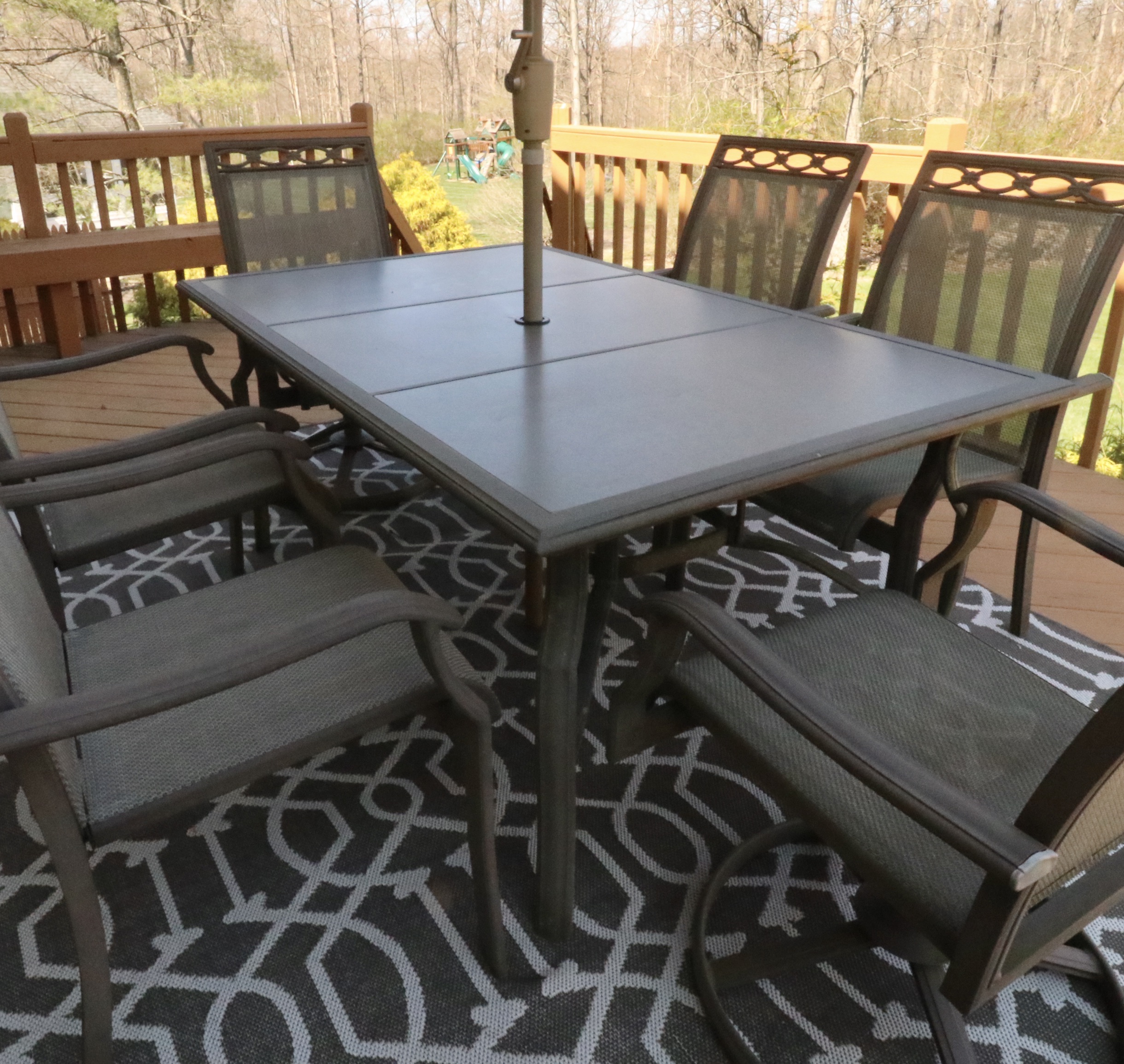 Cast Aluminum Outdoor Dining Set with Sling Mesh Seating, Umbrella and Area Rug