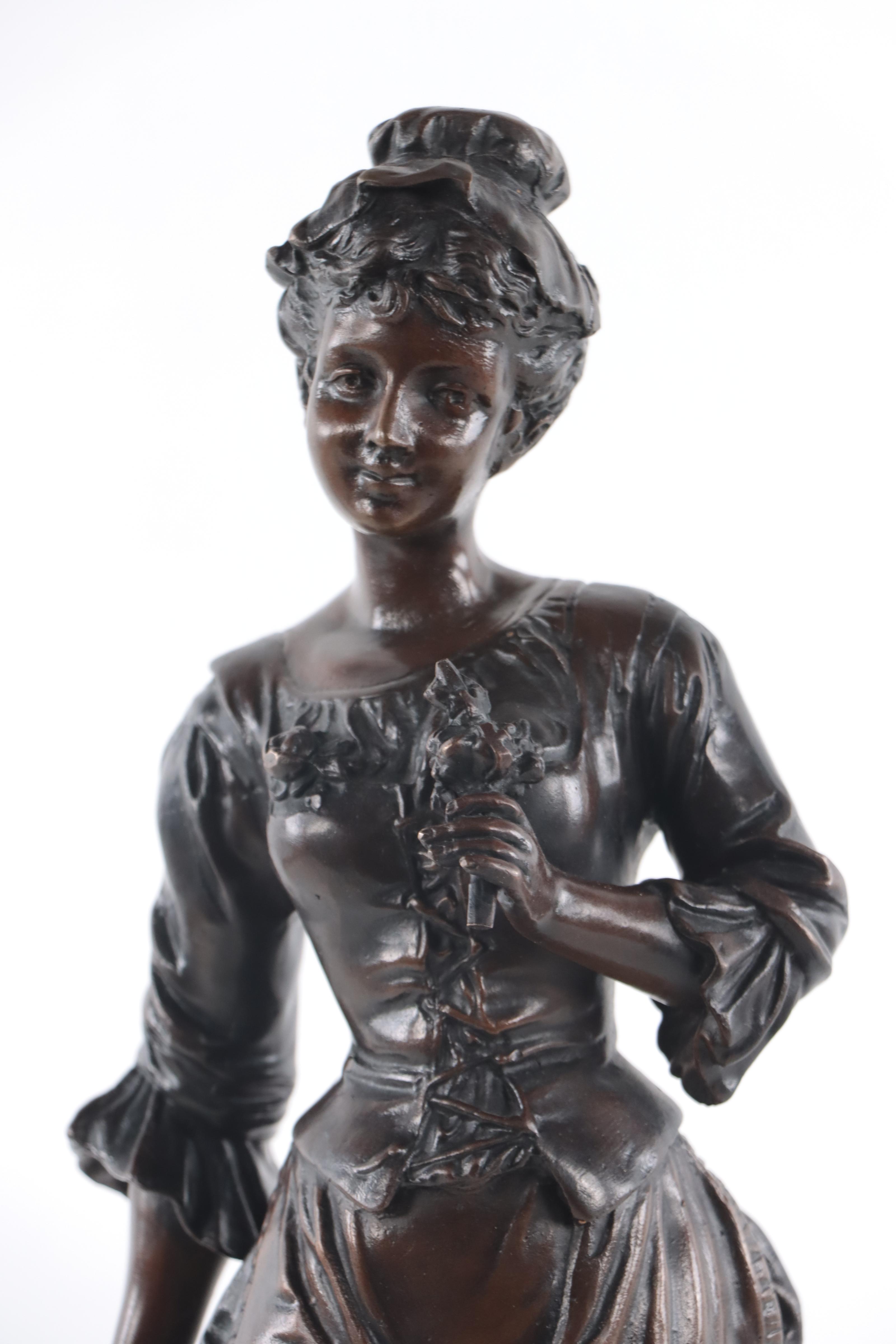 Bronze Sculpture of Woman Holding Flowers