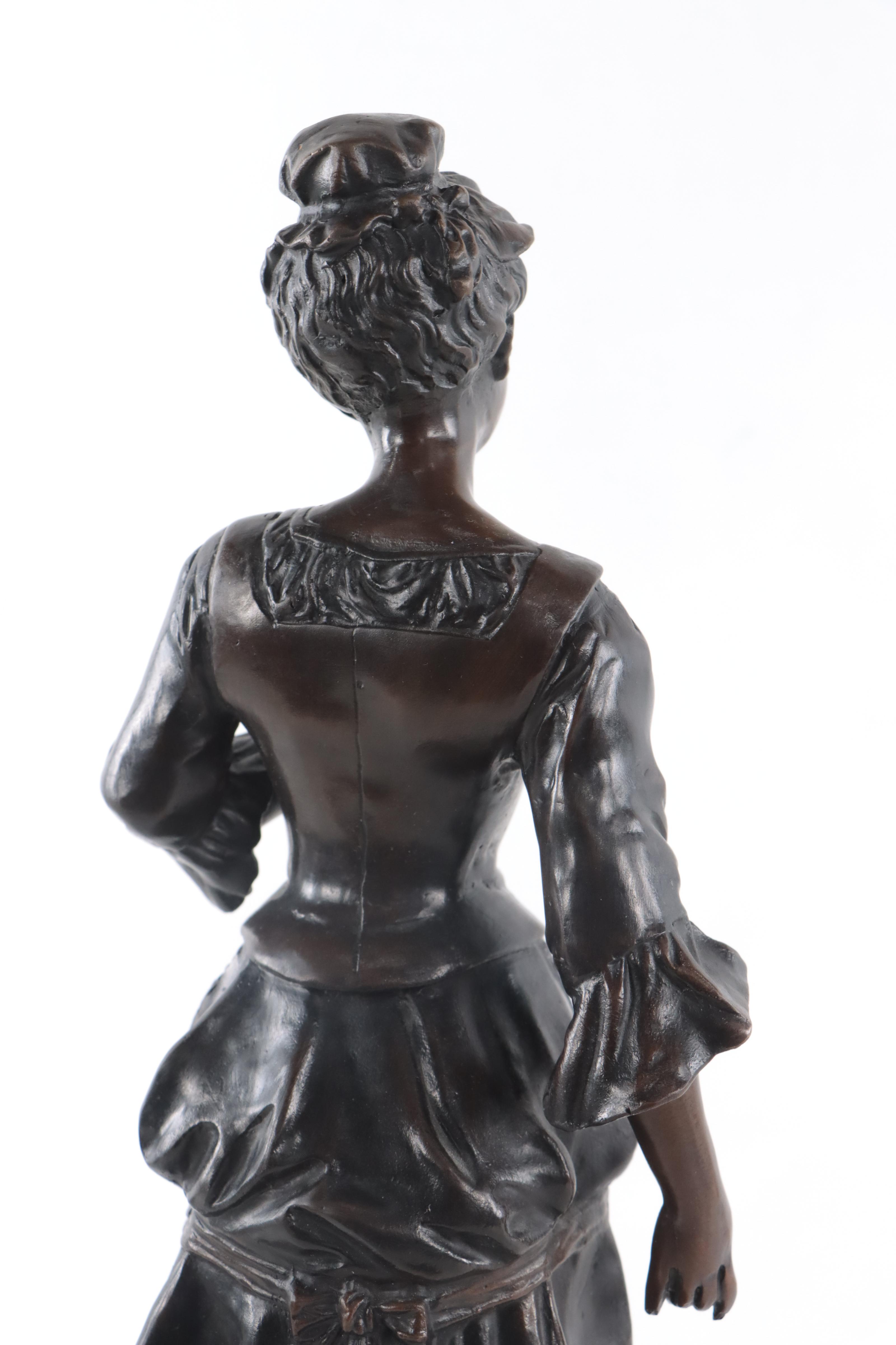 Bronze Sculpture of Woman Holding Flowers