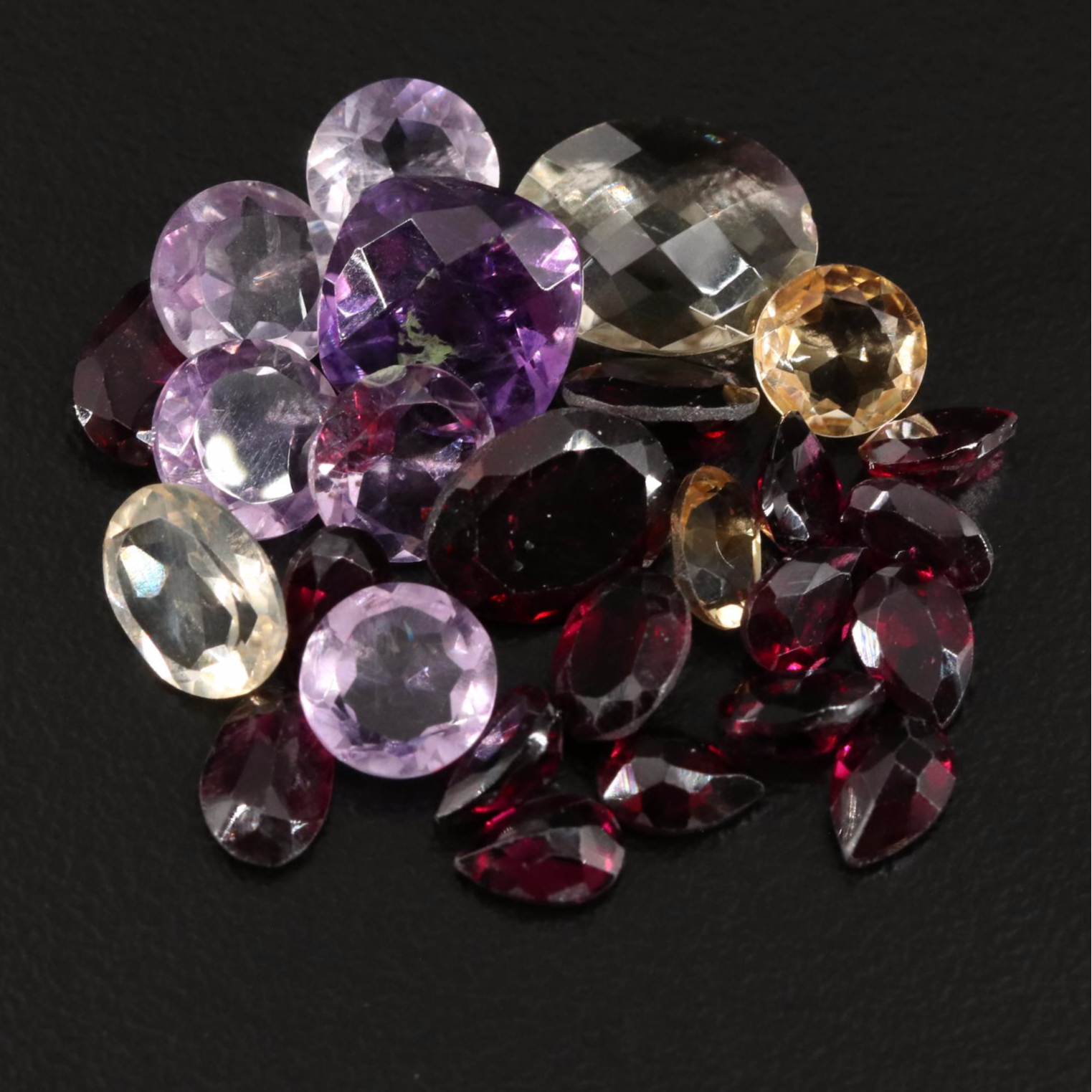 Loose 25.00 CTW Amethyst, Citrine, and Garnet Lot