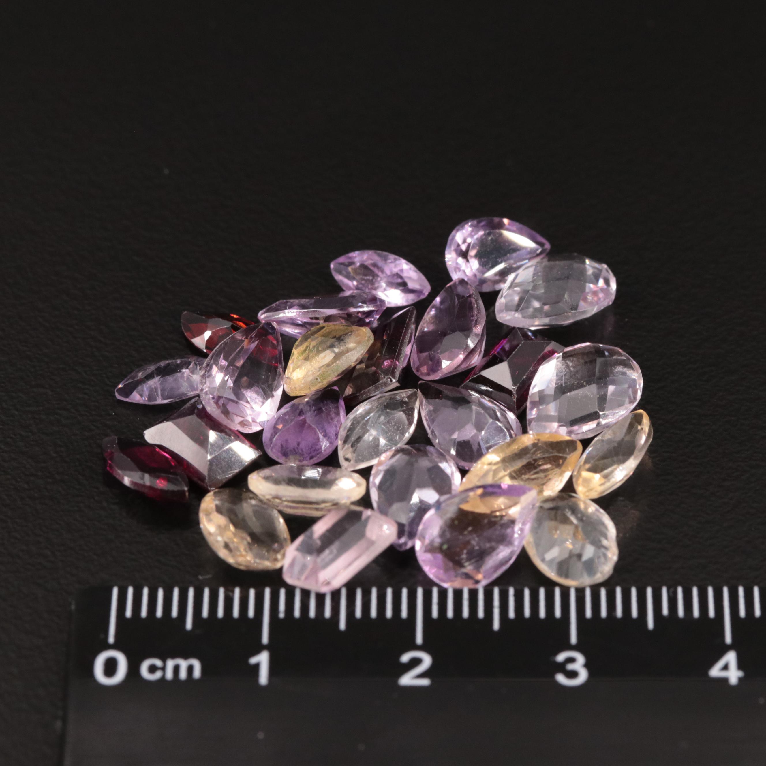 Loose 24.54 CTW Amethyst, Citrine, and Garnet Lot