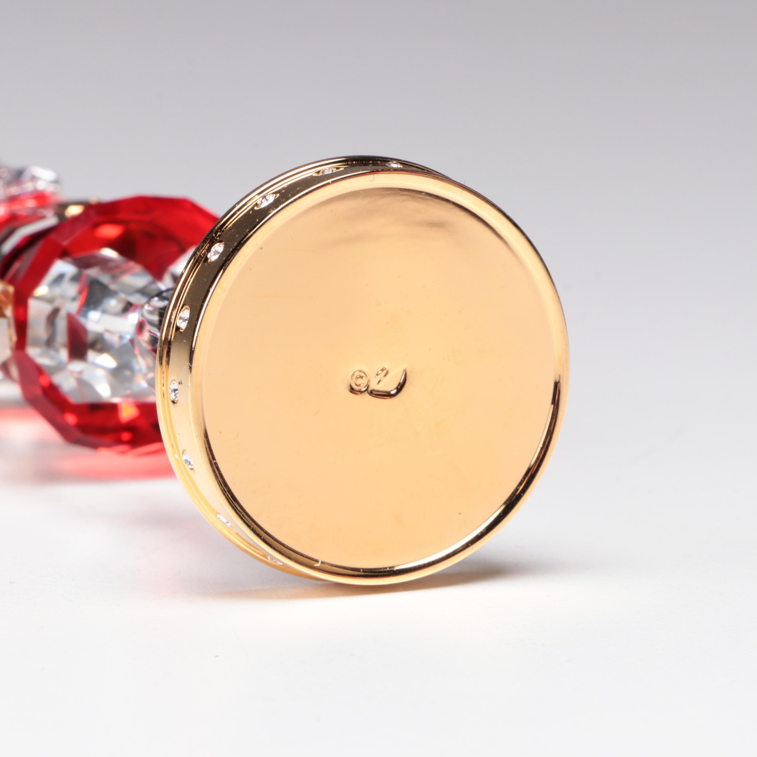 Swarovski Crystal Nutcracker and Poinsettia Figurines