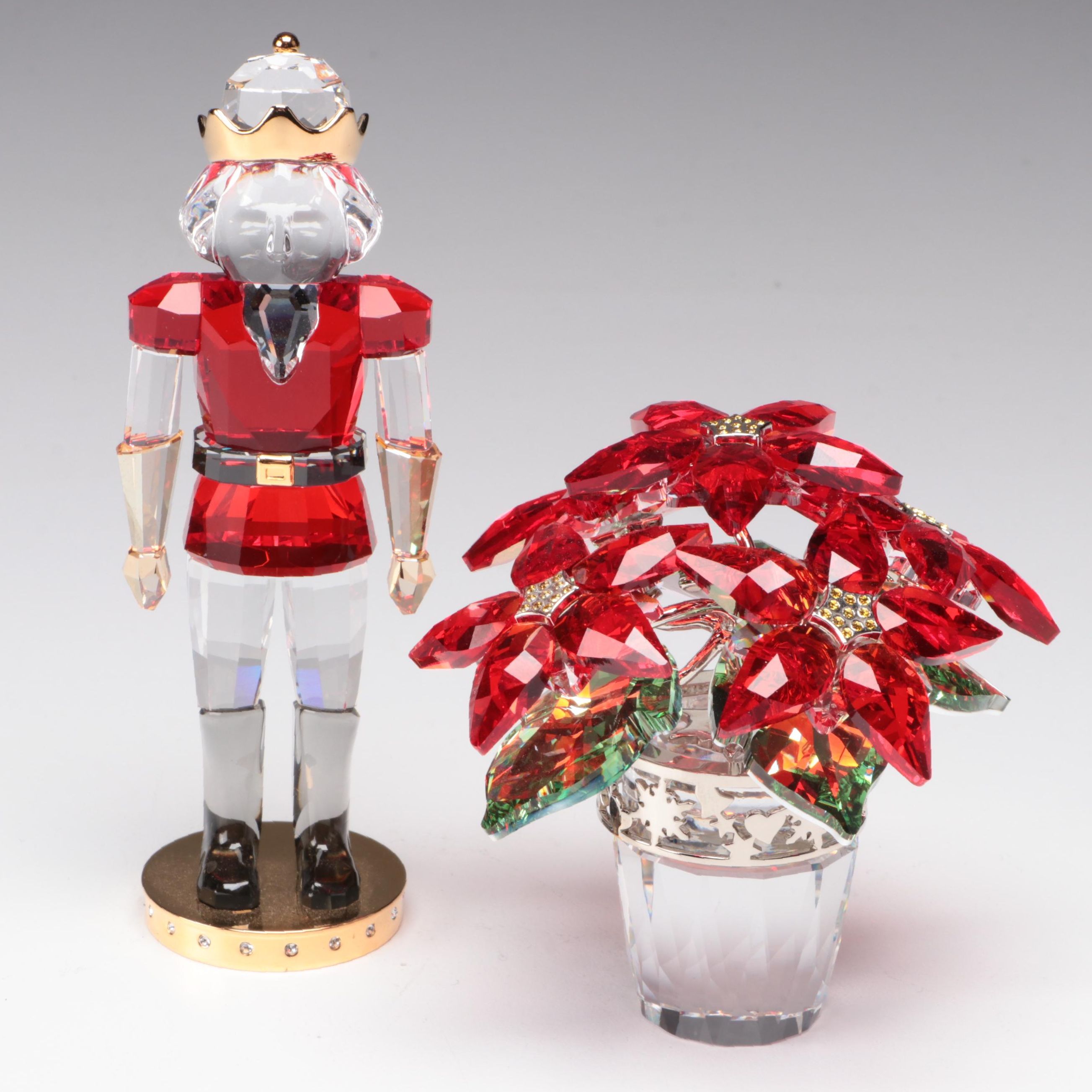 Swarovski Crystal Nutcracker and Poinsettia Figurines
