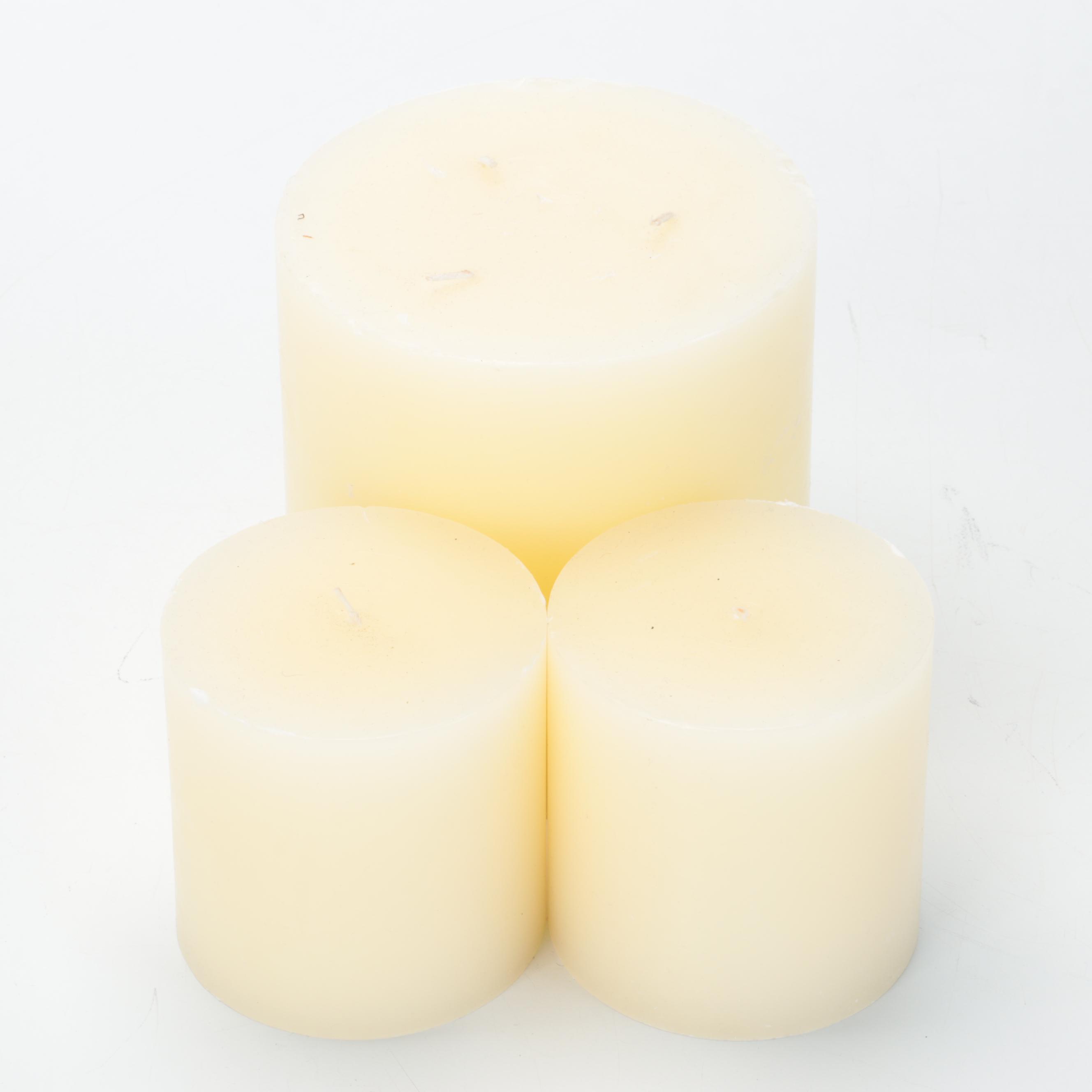 Three Metal Wall Candle Sconces With Pillar Candles