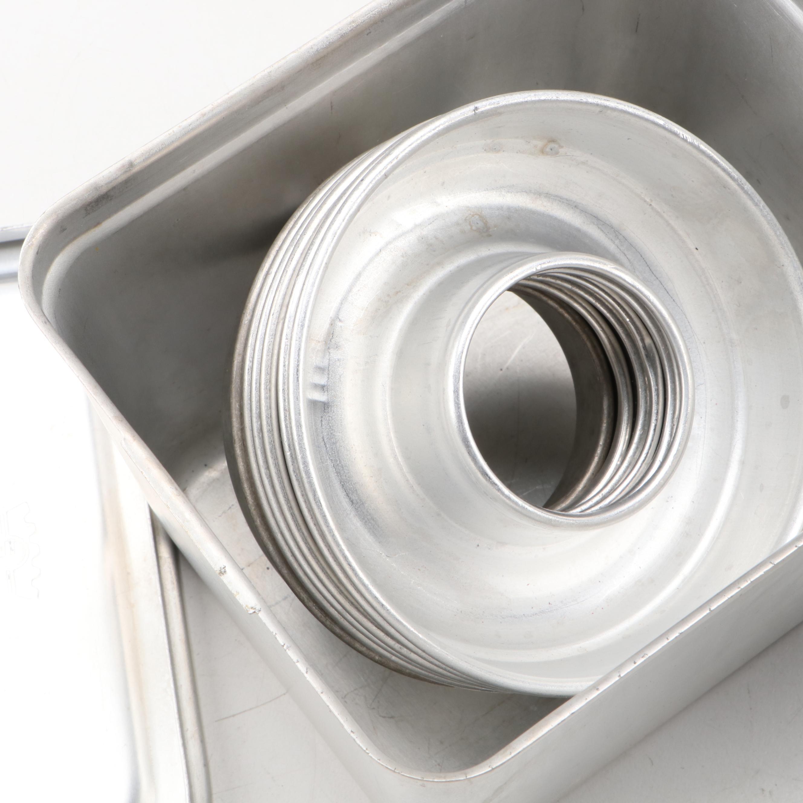 Griswold and Other Cast Iron Pans with Blue Bird Pie Pans and Other Kitchenware