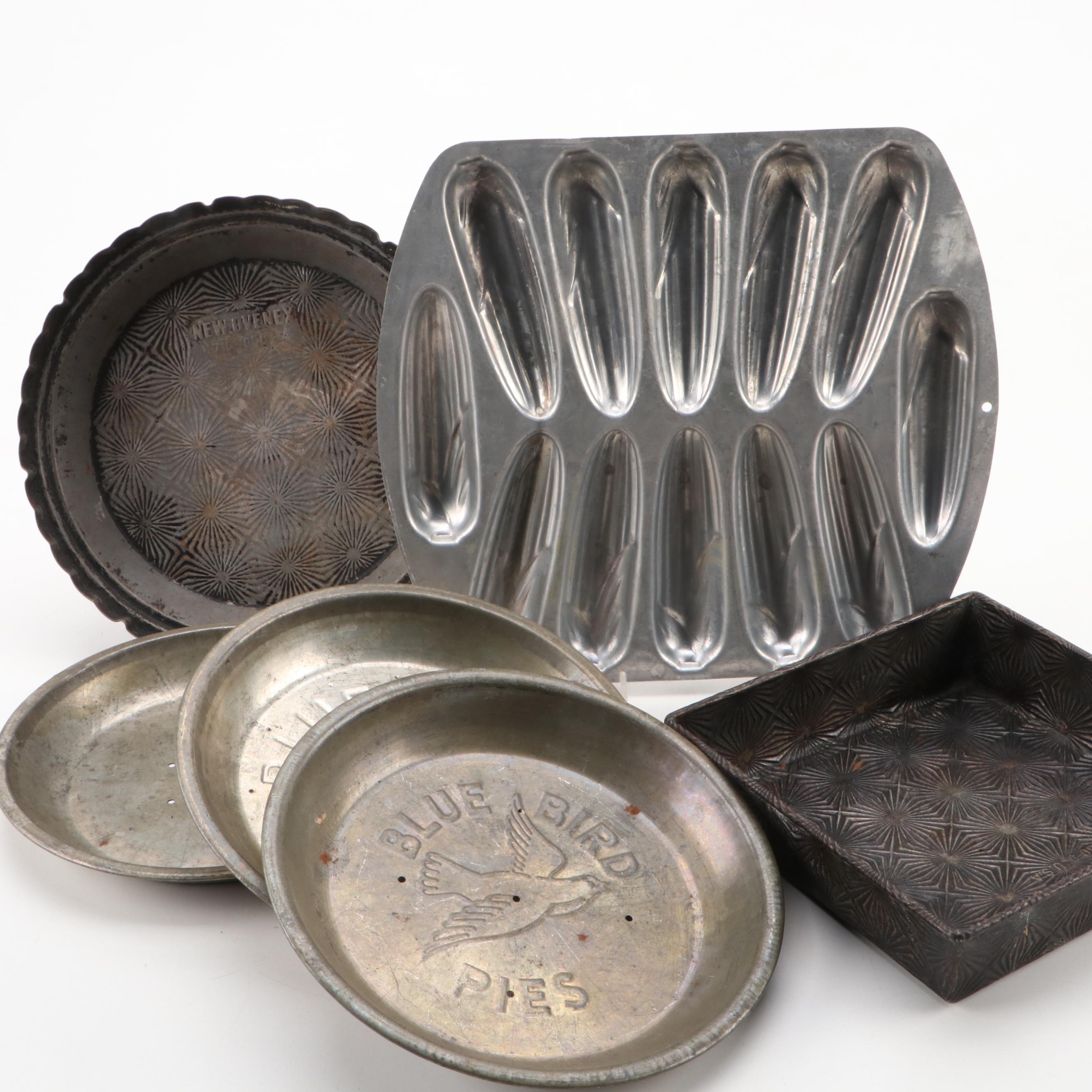 Griswold and Other Cast Iron Pans with Blue Bird Pie Pans and Other Kitchenware