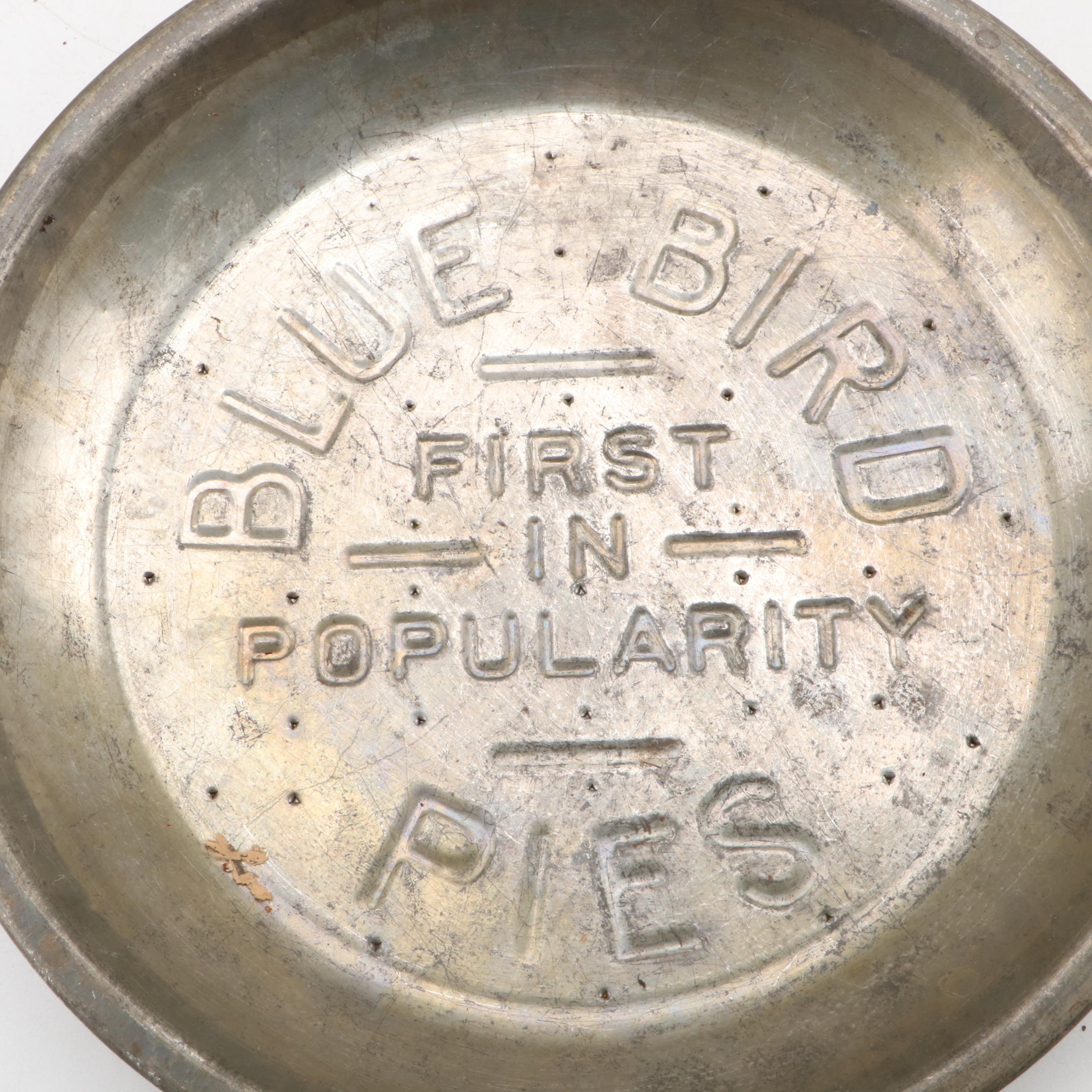 Griswold and Other Cast Iron Pans with Blue Bird Pie Pans and Other Kitchenware