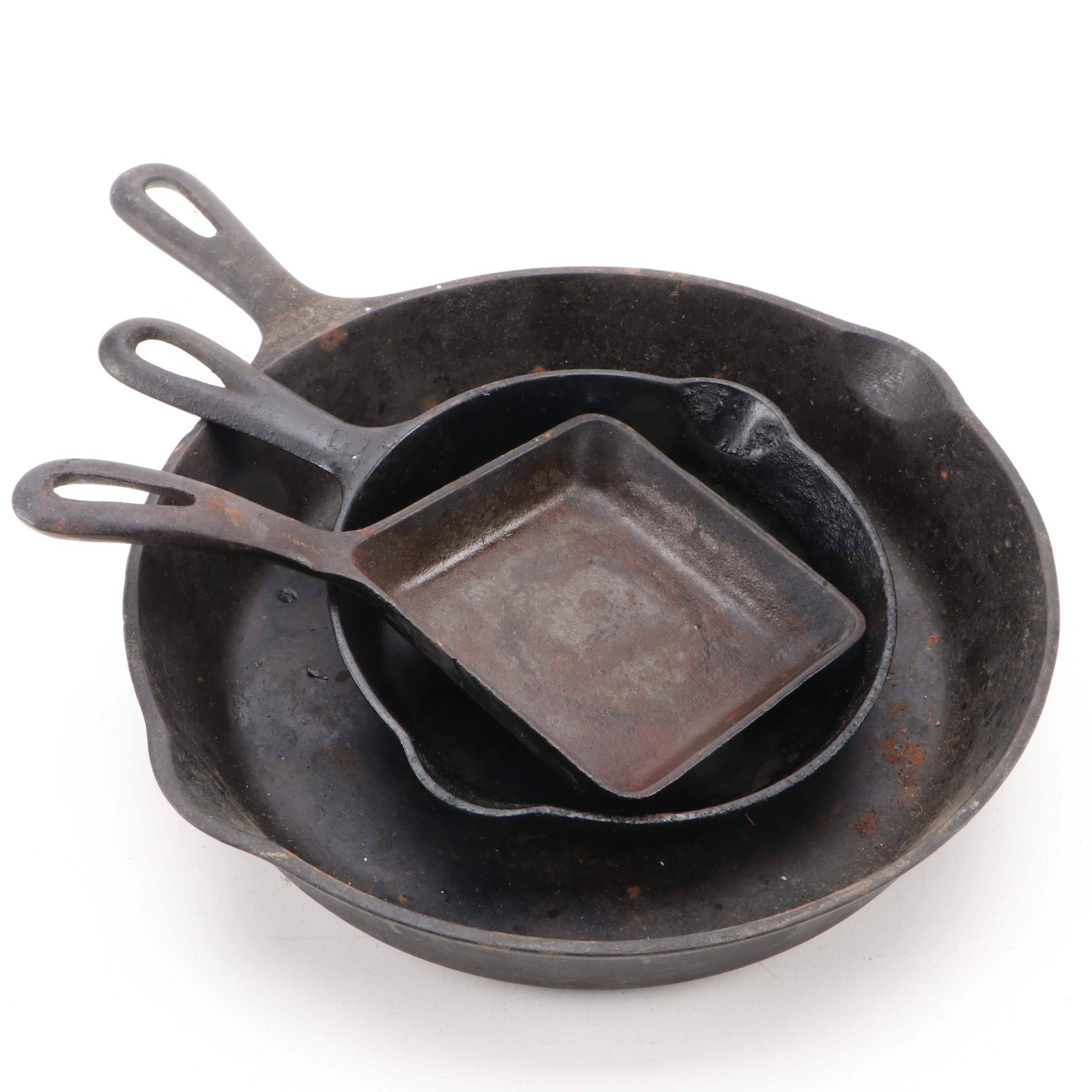 Griswold and Other Cast Iron Pans with Blue Bird Pie Pans and Other Kitchenware