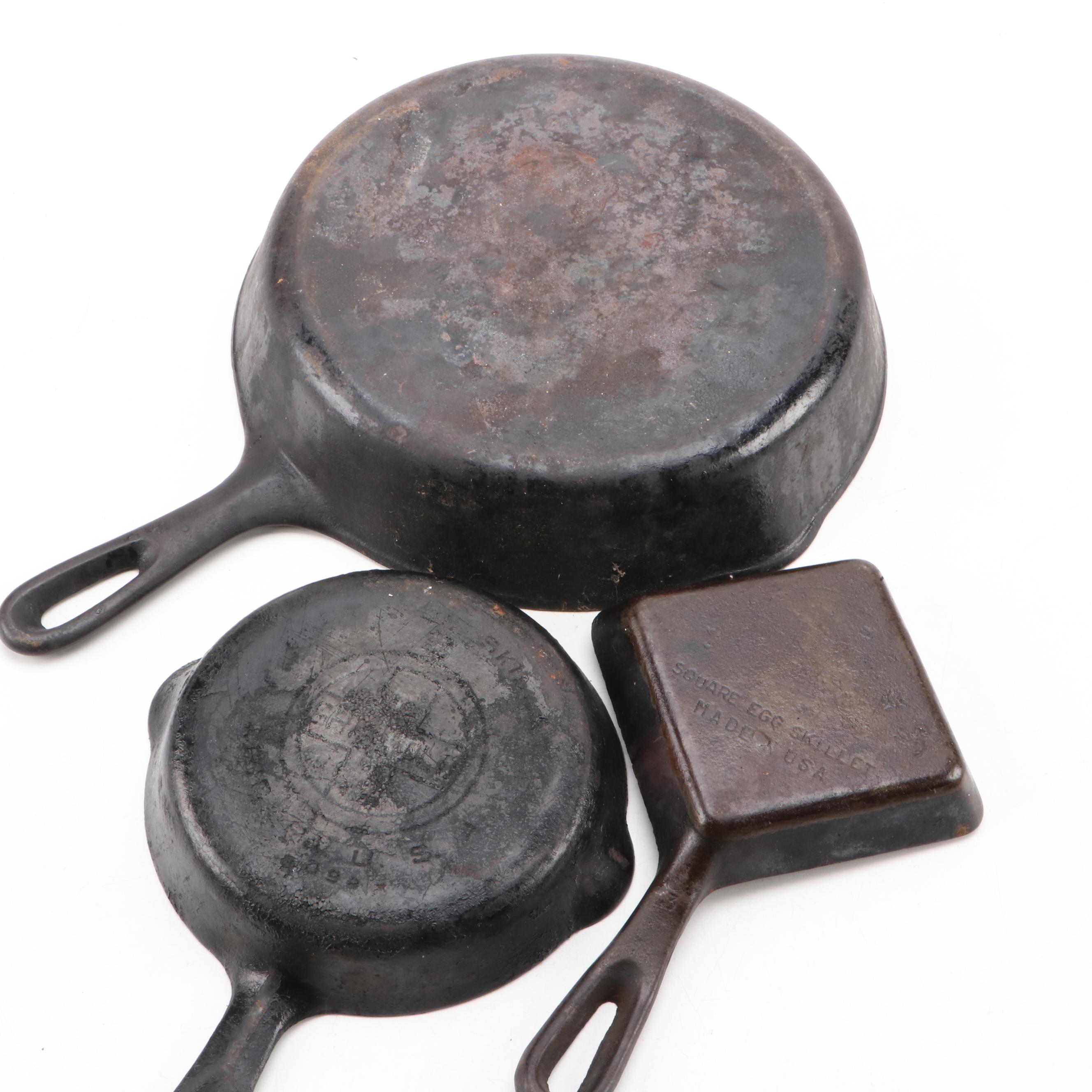 Griswold and Other Cast Iron Pans with Blue Bird Pie Pans and Other Kitchenware