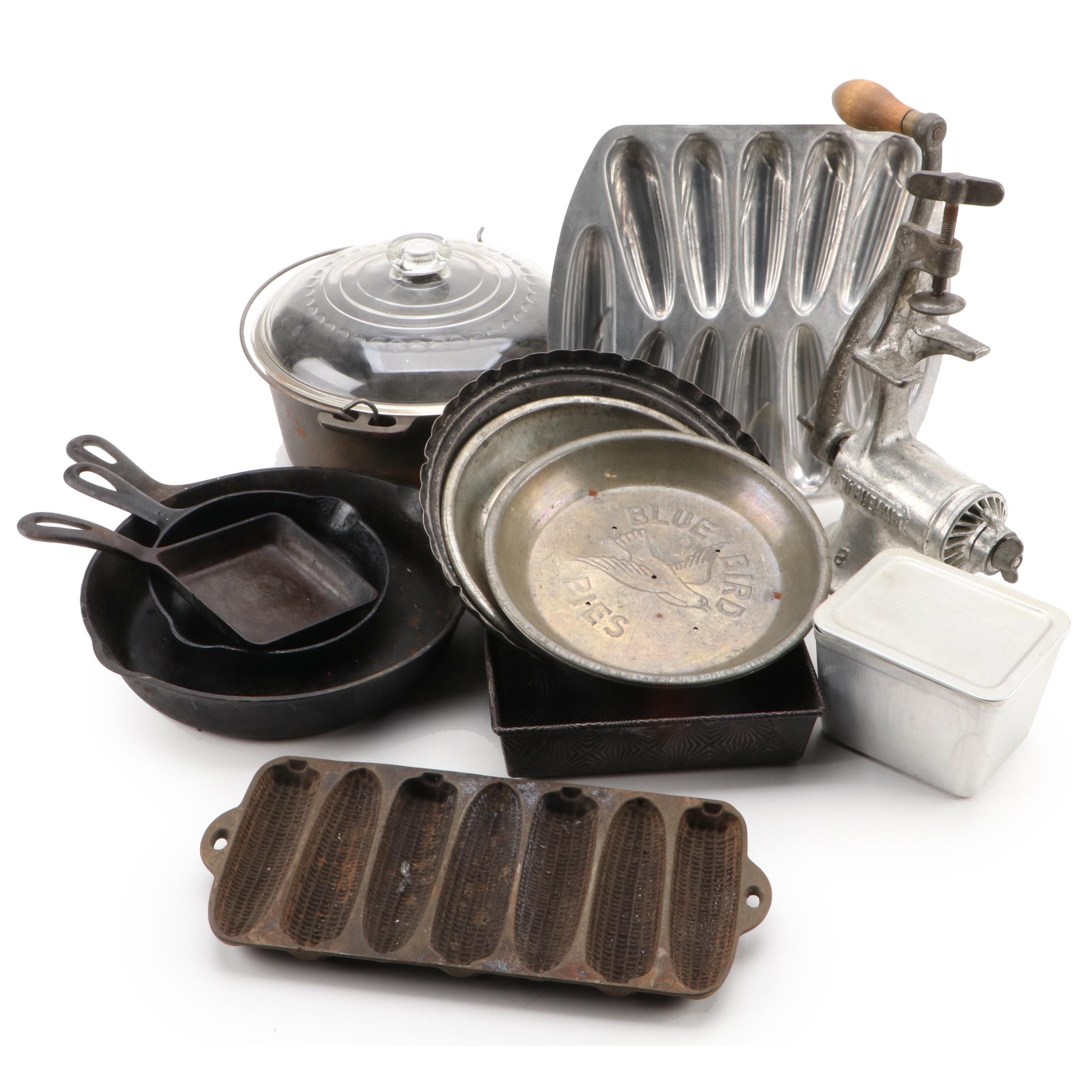 Griswold and Other Cast Iron Pans with Blue Bird Pie Pans and Other Kitchenware