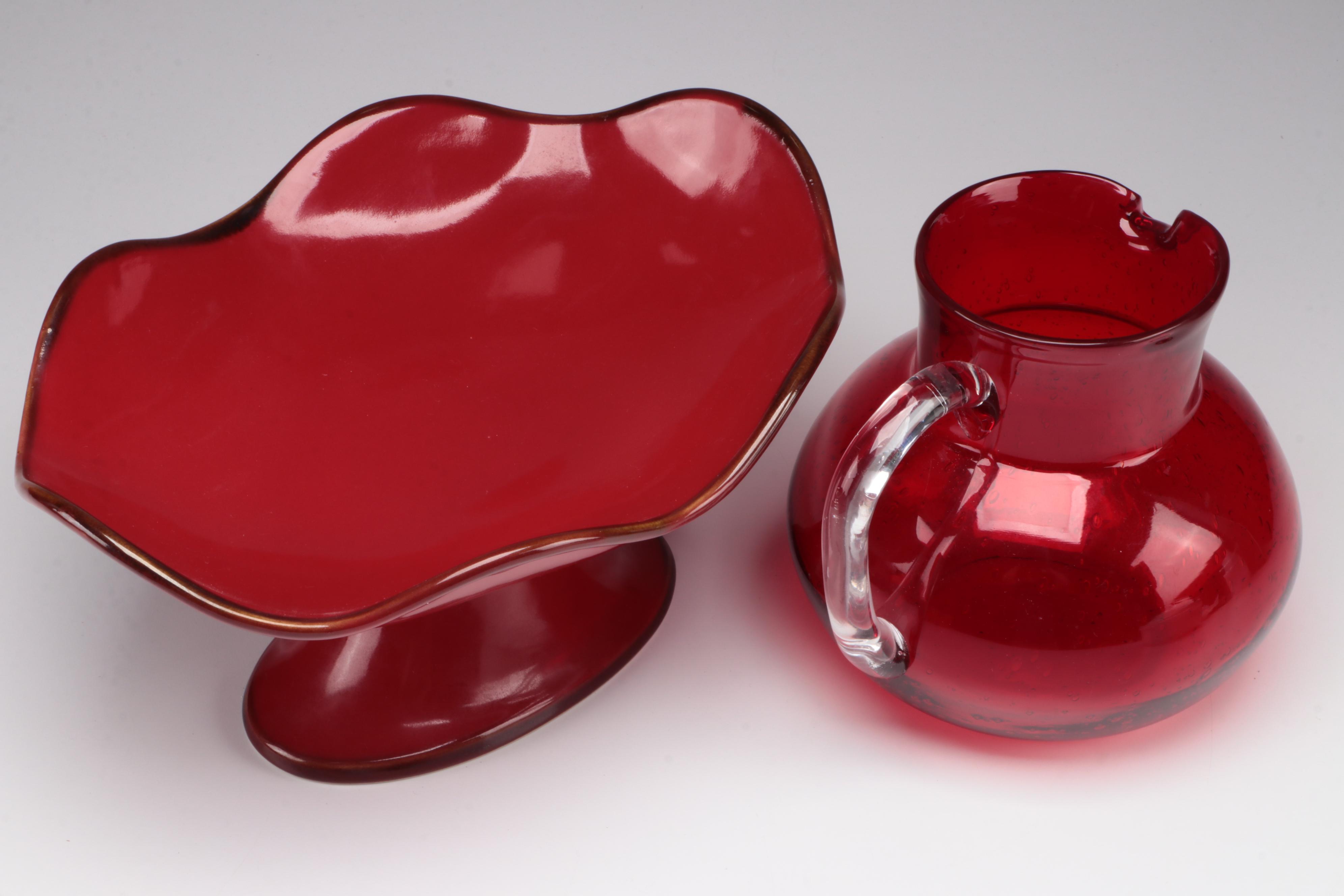 Red Glass Pitcher with Other Stoneware Dishes and Bowls